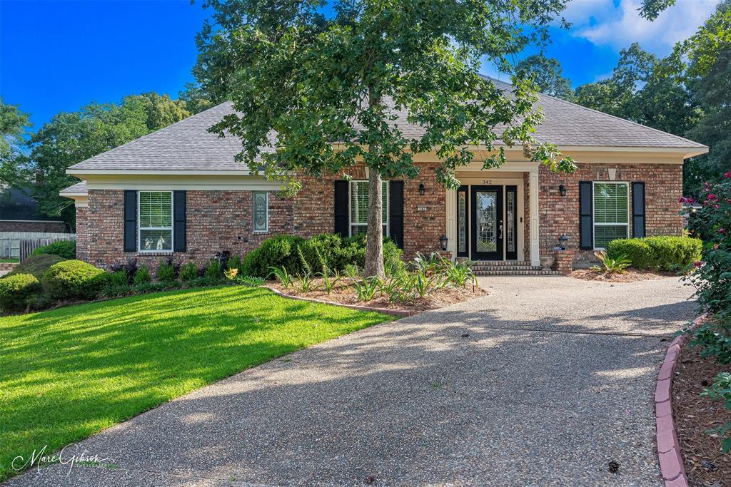 Wonderful one-story home on a charming street in Southern Trace, South Shreveport’s coveted gated golf course community. Ideally located near the clubhouse, grill, pickleball courts, community pool, tennis courts and more, this home offers a desirable lifestyle with exceptional convenience to neighborhood amenities. The interior features neutral finishes and blinds throughout, along with a wonderful floor plan featuring a dedicated Foyer, Formal Dining Room and spacious Living Room with built-ins. The Chef’s Kitchen offers updated appliances, granite countertops, great storage and a bar area open to the Living Room, making it ideal for entertaining. The Kitchen is flanked by a lovely Breakfast Room, while an informal Den provides flexible space for a playroom, office, gym or additional living area. The Breakfast Room opens to a wonderful rear yard with a covered patio, fountain and beautiful mature landscaping, including several fruit trees. The home also features a nice Laundry Room with storage and a utility sink. Additional parking along the side of the home provides excellent space for guests, and a motorized gate between the front and back yards adds both convenience and privacy. The lovely Master Suite includes wood floors and a nice ensuite bath with a soaker tub, separate shower, knee space for makeup, double vanities and double closets. Two spacious guest bedrooms at the front of the home share a Jack and Jill Bathroom, while an additional private guest suite offers its own full bathroom. Additional updates include new windows throughout, two new water heaters, an attached two-car garage with two new EV chargers, a new security system and a large whole-house generator installed less than two years ago. A wonderful opportunity to purchase a meticulously maintained home with updates throughout in one of South Shreveport’s most desirable neighborhoods.