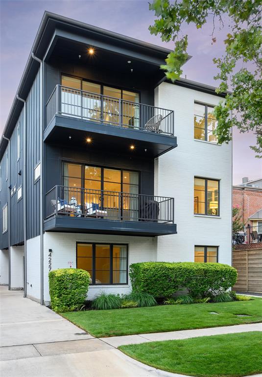 This rare street-facing front unit in the heart of North Oak Lawn offers townhome-style living, thoughtful design and an unbeatable location. Tucked along a quiet, tree-lined street, this home offers walkability and convenience that's hard to come by: stroll to Whole Foods, the Oak Lawn corridor, Shops of Highland Park and even Highland Park Village.  Step inside to a welcoming entry adorned with playful wallpaper, setting a stylish tone from the moment you walk in. The first floor also features an ensuite bedroom with hardwood floors and custom drapery, along with a 2-car garage for effortless parking and storage.  Upstairs on the second level, an abundance of natural light pours through oversized windows in the dining room, complemented by elegant window treatments throughout. The adjoining living room opens to one of two expansive balconies via sliding doors, perfect for morning coffee or evening unwinding. Hardwood floors and drapery continue the home's polished aesthetic, while the kitchen impresses with a full suite of KitchenAid appliances, including a 4-burner range, microwave, and French door refrigerator with a freezer drawer. A chic powder bath with statement wallpaper and a convenient pantry round out this level. The third floor is dedicated entirely to rest and retreat. The primary suite includes a private sitting area and its own access to the second oversized balcony, complete with sliding doors and window treatments. The spa-like primary bath stuns with marble floors, a standalone soaking tub, separate shower, dual vanities, and an oversized boutique style closet offering ample storage. A flexible office or sitting area offers even more natural light, while the utility space accommodates a full-size washer and dryer with custom built-ins for added organization. With its rare street-facing position and curated design this home offers a blend of character, comfort, and style.  Thoughtfully maintained including a recently replaced (2024) Trane HVAC.