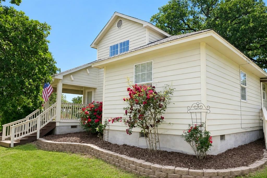 Welcome to your peaceful retreat in Chico, Texas where comfort, charm, and wide-open space come together beautifully on 2.3 acres. The standout features of this home are the inviting covered front and back patios surrounded by nature and the large established garden perfect for the garden enthusiast and homesteaders! Step inside to a bright, open interior filled with natural light and thoughtful updates throughout. The spacious eat-in kitchen is truly the heart of the home, with a large center island, abundant counter space, and cabinets ideal for both everyday living and hosting gatherings. Updated kitchen and bathrooms, along with recently replaced flooring throughout the home, give it a fresh, modern feel.
Upstairs, a versatile bonus room offers endless possibilities ready to adapt to your lifestyle. Outdoors, the property is a dream for anyone who loves to garden or embrace a more self-sufficient lifestyle. Enjoy the large, established garden area along with a variety of fruit trees, including peach, fig, plum, apple, pomegranate, cherry, mayhaw, and mulberry. Multiple grapevines line the fence in the back adding both beauty and function, creating a truly special outdoor setting. For those needing workspace or storage, the property also includes a 480 sqft. shop with electric, wired for 220V, perfect for a welder or other equipment. If you’re looking for peaceful country living with modern updates and room to grow, this Chico property that borders Alvord is ready to welcome you home!