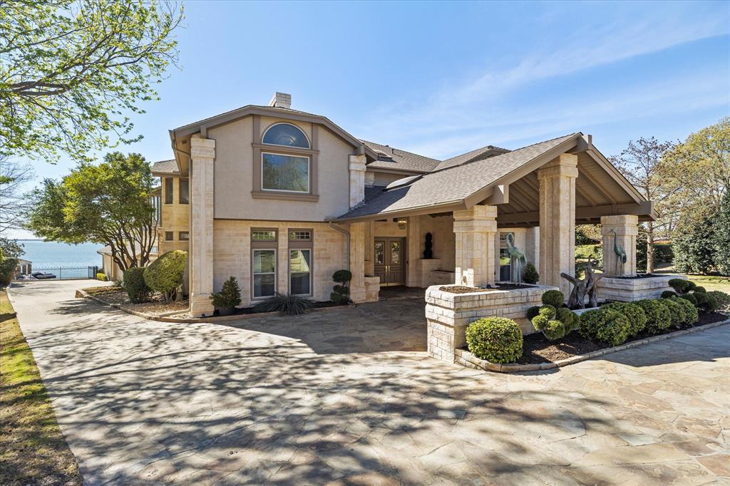 A Rare Lakefront Masterpiece! Discover an extraordinary, nearly 9,000 sq. ft. lakefront estate that offers the pinnacle of luxury living.
Perfectly positioned for breathtaking skyline & water views, this one-of-a-kind residence boasts a private boat dock, a resort-style pool, & an expansive outdoor living area complete with a summer kitchen & fire pit—an entertainer’s dream. A grand porte-cochère welcomes you to this meticulously maintained home, where a soaring foyer opens into an elegant living space & a stately dining room with a fireplace, ideal for hosting 
 unforgettable gatherings. The chef’s kitchen is a true showpiece, seamlessly flowing into a bright breakfast area. Designed for both entertainment & relaxation, the home features a spacious game room & family room, complete with a full wet bar, all opening to the outdoor paradise. The owner’s suite is a private retreat, offering a serene sitting area, an oversized spa-inspired bath, & mesmerizing lake views. Upstairs, a sprawling living area showcases unmatched sunset & skyline vistas, extending onto a Florida room for year-round enjoyment. Work from home in the stunning office, where panoramic lake views inspire productivity. Guests will feel indulged in their private suites, each with large walk-in closets & luxurious baths.
This home is truly without comparison, offering an unparalleled waterfront lifestyle. Schedule your private showing today!