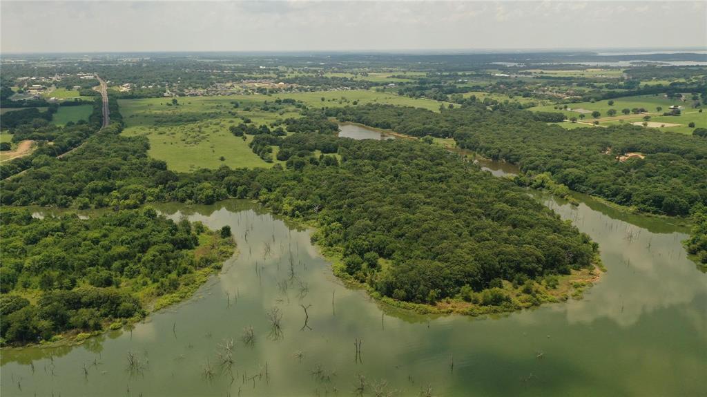 Waterfront property on Lake Ray Roberts. Great ranch or development property with beautiful acreage. Minutes from downtown Pilot Point City Center and less than 2 miles from Ray Roberts Lake State Park, the most visited State Park last year with 885,000 visitors! Front (south) acreage of property is in city limits and back (north) piece of property is in Denton County, allowing flexibility for access to utilities. Electrical and sewer accessibility available at Holford St. Ag exempt.This listing can be combined with MLS# 20538226, 45.16 acres for  approximately 105 acres total.