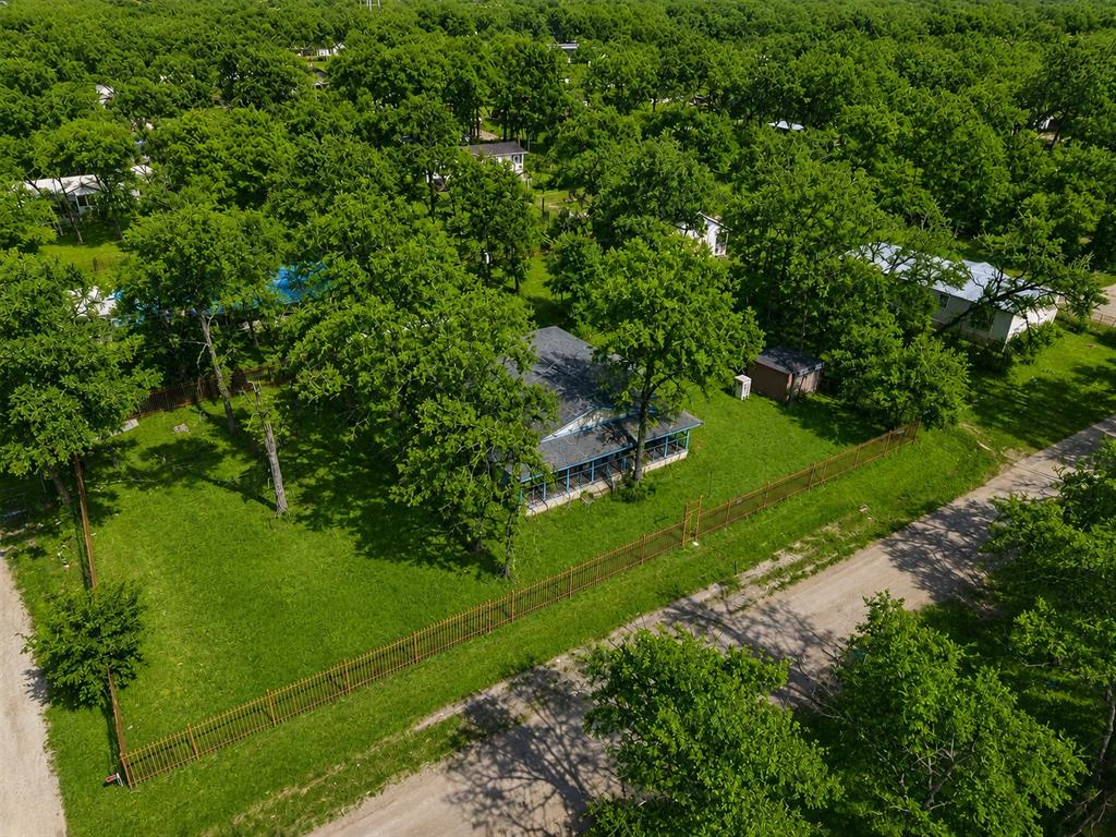 Three adjoining lots offer a rare opportunity in an area experiencing ongoing growth and redevelopment. The property includes a 2-bedroom, 1-bath home with wraparound porches, a detached shop, and mature trees throughout the site. The existing improvements are in need of renovation and are being offered as-is, presenting an opportunity for investors, builders, or buyers seeking a project with significant upside potential. Located just minutes from the reservoir and surrounded by a mix of established homes and new construction, the property offers flexibility for renovation, redevelopment, or other future uses. With multiple lots included, buyers may wish to explore subdivision or development possibilities. Properties with this combination of location, land size, and potential are becoming increasingly difficult to find.