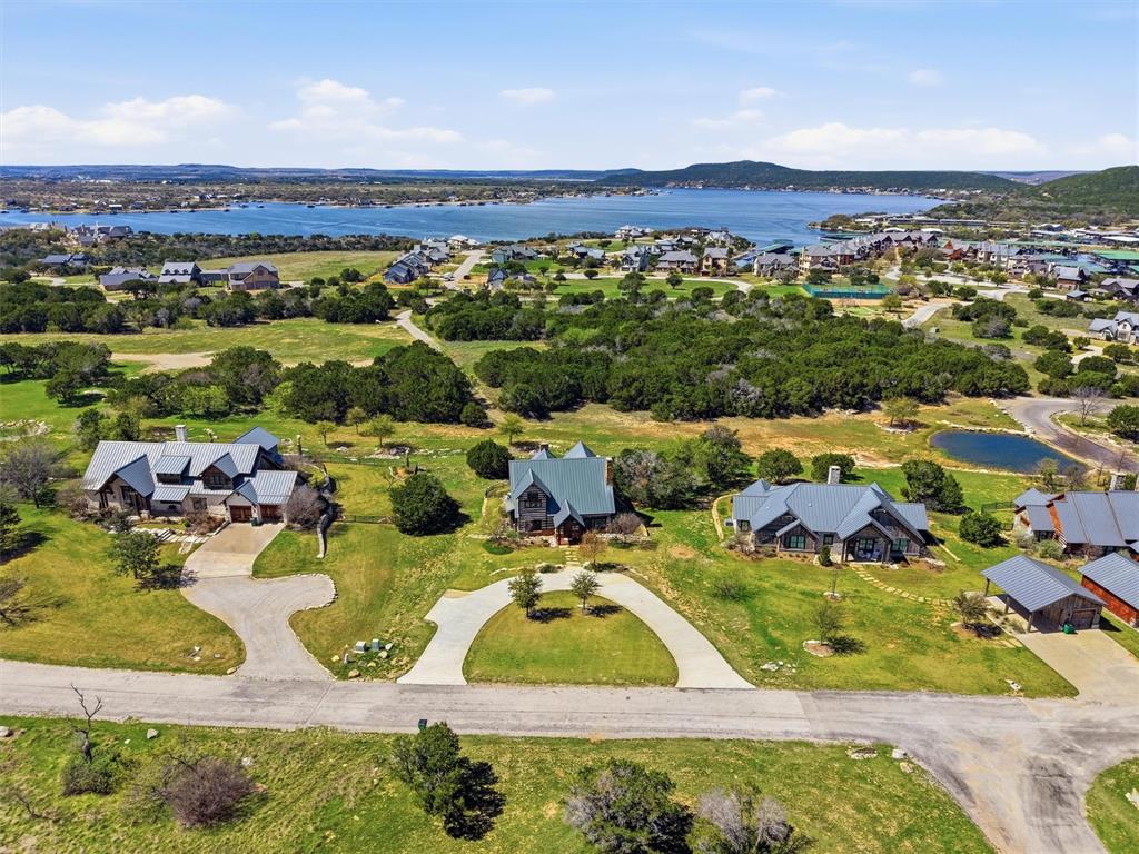 Experience refined rustic living in this turnkey cabin located in the amenity-rich Harbor community. Thoughtfully designed for both relaxation and entertaining, this stunning retreat features 4 spacious bedrooms, each with its own private ensuite bath, plus an additional half bath for guests.

The open-concept living, kitchen, and dining area creates a seamless flow, highlighted by warm finishes and inviting textures that perfectly complement the cabin’s elevated aesthetic.

Step outside to an expansive outdoor patio designed for year-round enjoyment, complete with a cozy fireplace and a private spool with a tranquil waterfall feature—your own personal escape after a day on the lake.

Offered fully turnkey, this property is ready for immediate enjoyment as a luxurious getaway, full-time residence, or investment opportunity. Located within The Harbor, residents enjoy access to resort-style amenities including pools, fitness center, sports complex, fishing ponds, and more.