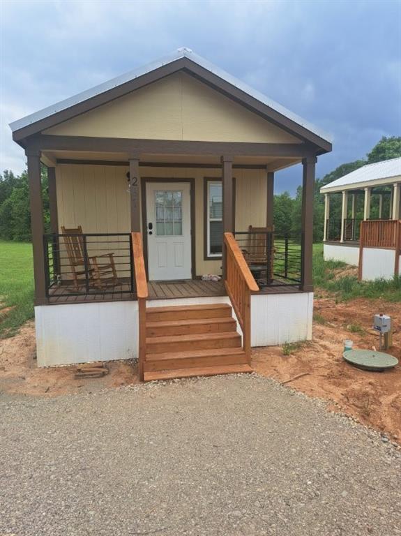 Escape to the best bass fishing in Texas! This beautiful tiny home has everything you need for you personal get away. Located in a community on Lake Fork, enjoy the neighborhood boat ramp, multiple pools, playground, and restaurant without leaving the neighborhood. In the evenings, sit on the covered porch and soak in the relaxation. There is nothing behind this house providing a serene view. The fully furnished house comes with a king-sized bed, sleeper sofa, washer and dryer combo and everything you need for a lake house. Lake Fork is a world-famous fishing lake hosting numerous tournaments a year. Just two hours from the Metroplex and 45 minutes to Canton Trade Days. Whether for full time living or part time escape, this home is quaint and inviting!