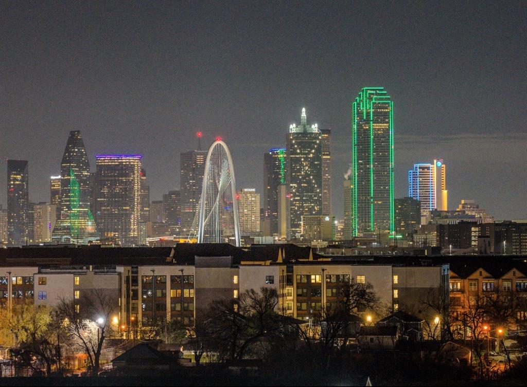 Single Family Home with Interior panoramic views of Downtown Dallas set this exceptional contemporary home apart. Located on a street lined with newly built residences, this thoughtfully designed property blends modern luxury with functional living across multiple expansive levels. Priced below appraised value! 

Inside, you’ll find multiple oversized living areas ideal for entertaining and everyday comfort. The chef’s kitchen is the true centerpiece, featuring double island's with seating for 9, a refrigerated wine room, a butler’s pantry, and abundant custom wrap around cabinetry. Multiple Built-in office desks provide dedicated workspace, perfect for remote professionals or students. Two Laundry Rooms plus a 8ft board on board cedar fence for interior and exterior privacy with a nice sized double yard!

This spacious home offers four bedrooms and four bathrooms, with privacy thoughtfully integrated into the design. A solid privacy wall separates the property from neighboring homes, creating a quiet and secluded setting. Three of the bedrooms each feature their own covered balconies, offering fresh air and elevated views. 

The primary suite includes access to a covered patio, creating a peaceful retreat with skyline views. The second room living area provide both indoor and outdoor entertaining space, complete with a spiral staircase leading to a stunning rooftop patio. From here, enjoy breathtaking panoramic views of Downtown Dallas. Shared walls are stairs. Security Cameras included 

Additional outdoor living spaces include a patio with both covered and uncovered areas, fan-cooled for year-round enjoyment. Whether hosting guests or relaxing privately, this home delivers seamless indoor-outdoor living with immaculate, unobstructed views of the Dallas skyline. Directly next door to the new Billion Dollar Lagoon

A rare opportunity to own a statement property with luxury finishes, dramatic architecture, and unforgettable city views.