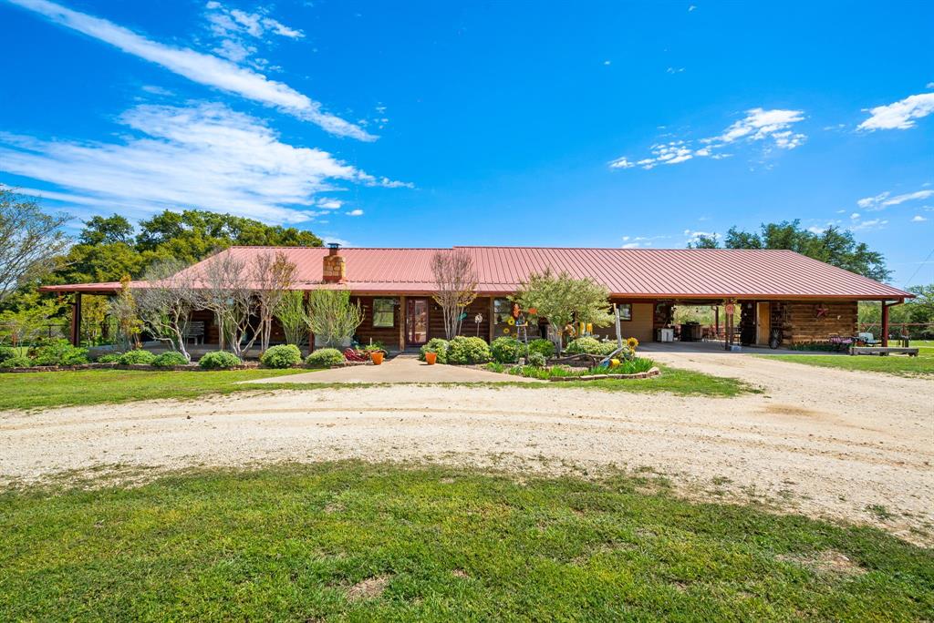 Welcome to 4155 County Road 188, located in the Cowboy Capital of the World, Stephenville, TX. This stunning property is nestled on a sprawling lot and offers a serene country living experience while still being just a short drive from all the conveniences of the city. Upon arriving at the property, you'll be greeted by a beautiful single-story log home with a spacious front yard and a welcoming front porch perfect for enjoying a morning cup of coffee or relaxing in the evening. The open concept layout flows seamlessly into the dining area and kitchen, making it the perfect space for entertaining guests or enjoying family dinners.  The home features three spacious bedrooms, each with ample closet space and natural light. Outside, the property features a large backyard with plenty of space for outdoor activities, a covered patio perfect for grilling and entertaining, and a storage shed. There is also a nice horse barn, chicken coop, equipment sheds and so much more! Great Horse property