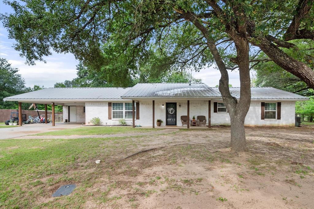 Welcome to this charming farmhouse-style home in Fairfield ISD! Featuring 3 bedrooms, 2 full bathrooms, and approximately 2,000 square feet, this beautifully updated home sits on almost half an acre with a fenced backyard perfect for entertaining, kids, or pets. The inviting exterior showcases crisp white paint with warm wood shutters and posts, topped with a durable metal roof that adds both charm and functionality.

Inside, you’ll find spacious rooms and a thoughtfully modernized interior featuring a charming fireplace in the living room, subway tile backsplash, and a beautiful butcher block island in the kitchen. Updated windows completed within the last few years give the home a fresh feel while helping improve energy efficiency. The primary bedroom offers an ensuite bathroom with dual sinks for added convenience, while the two additional bedrooms provide plenty of room for family, guests, or a home office setup. The kitchen includes a gas range ideal for cooking enthusiasts, and the attached two-car carport adds everyday convenience.

Conveniently located within walking distance to parks, walking trails, and schools, this move-in ready home truly has it all. What a place to call home — this is a must-see!