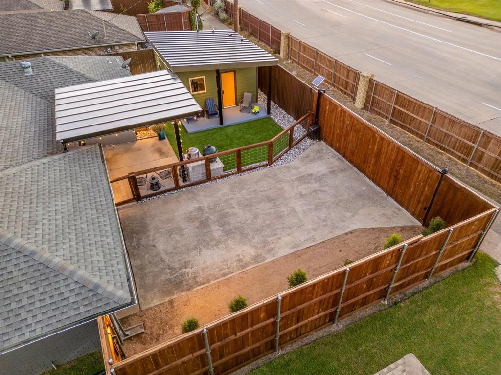 Stunning one-story modern remodel in an established Richardson ISD neighborhood, with a detached casita and a backyard built for entertaining. This 3-bed, 2-bath home (2,229 sq ft) welcomes you with vaulted beamed ceilings, hardwood floors, and an open-concept living room anchored by a floor-to-ceiling stacked-stone fireplace and walls of sliding glass. The chef's kitchen shines with white shaker cabinetry, a gray island, quartz counters, subway-tile backsplash, stainless appliances, gas cooking, and a farmhouse sink. The primary suite features a sitting area, a custom walk-in closet, and a spa bath with a freestanding tub, a walk-in rain shower, and a dual vanity. A flex room opens to the patio, and the detached climate-controlled casita with full bath makes an ideal office, gym, or studio. Outside: covered patio, turf lawn, water feature, and 2-car garage. Minutes to DNT, 635, PGBT, and 75.