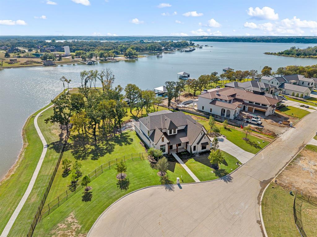 The stunning executive home is located in highly acclaimed community -The Resort on Eagle Mountain Lake. This home backs to a canal with lake access. This fabulous home boast 5 bedrooms.  Two bedrooms, including the primary are on the first floor. The first-floor main living area is huge open concept that opens to the back patio with canal access. Upstairs living features huge game room and 2 additional bedrooms. An amazing home with its own custom Swimming pool, private boat dock! You will never want to leave home! This is a must see and will not last long.