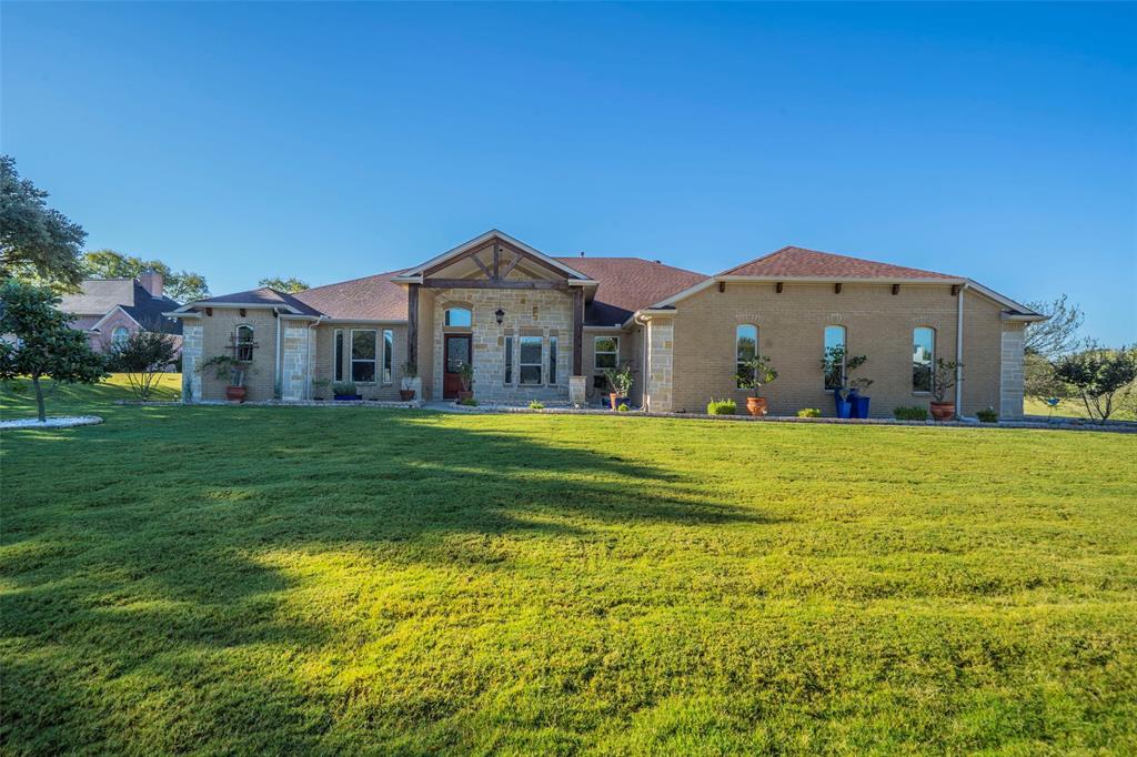 Yes—there's a 3-car garage!

Welcome to this exceptional custom-built home situated on nearly 2 acres in the highly desirable Lake Ridge community. Built just seven years ago, this meticulously maintained residence showcases quality craftsmanship, thoughtful design, and timeless appeal.

From the moment you enter through the grand foyer, you'll appreciate the attention to detail and pride of ownership. Extensive planning went into the home's construction, beginning with an engineered foundation featuring multiple piers beneath the slab and a 30-year warranty.

Designed with both comfort and functionality in mind, the flowing floor plan offers flexible living spaces. A standout feature is the oversized dressing room adjoining the primary suite, which conveniently connects to the spacious laundry room.

The luxurious primary retreat offers ample room for a sitting area, home office, fitness space, or nursery. The spa-inspired ensuite bath features a two-person walk-in shower, soaking tub, dual vanities, and custom built-in cabinetry.

Throughout the home, rich wood, tile, and carpet flooring create warmth and character. The chef's kitchen is equipped with a propane gas cooktop, electric double ovens, and a large walk-in pantry—ideal for everyday living and entertaining.

A spacious game room provides the perfect gathering space, complete with a stylish bar area and room for a full-size pool table.

Step outside to an expansive covered patio overlooking the peaceful acreage. Enjoy morning coffee or evening sunsets while taking in the tranquil surroundings.

With multiple bonus rooms offering endless possibilities, this one-of-a-kind property delivers the perfect blend of luxury, comfort, flexibility, and thoughtful design.

Don't miss the opportunity to make this remarkable Lake Ridge property your next home.