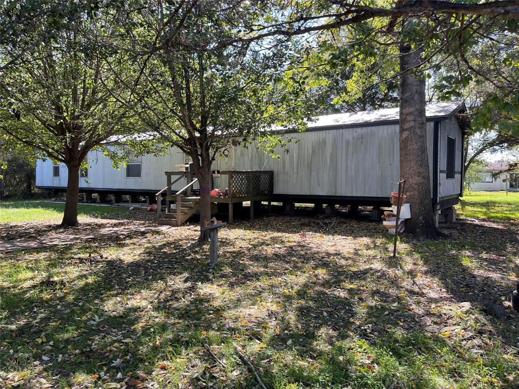 Approx 6.4750 acres near town just off of Post Oak Road, Convenient to Jr. & Sr. High Schools, wooded with nice seclusion, 3 bed, 2 bath mobile that needs repairs, tied down & on slab (see pictures), all contents are included, sold AS, IS, community water, septic tank.
