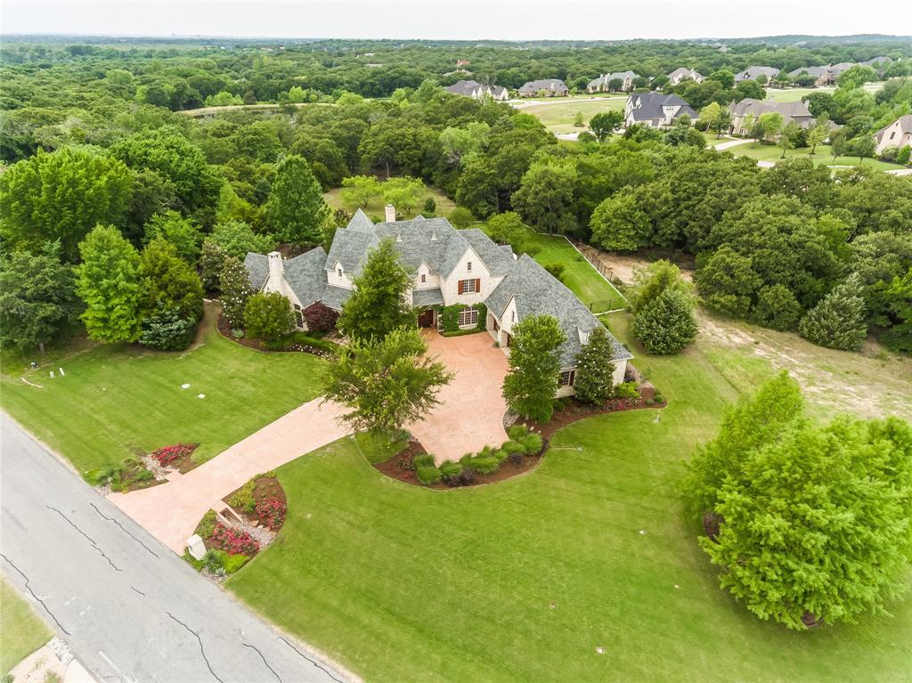 CUSTOM MASTERPIECE WITH A BACKYARD SANCTUARY OFFERING COMPLETE SOLITUDE & PRIVACY! The breathtaking backyard boasts a pool & spa, covered patio with automatic sun shades, outdoor fireplace, built-in grill, landscaping that attracts birds & butterflies, a fire pit area & scenic views of the conservation land surrounding the property. Top-notch finishes in this majestic estate include custom plantation shutters & cabinetry, handscraped wood floors, a 1000 bottle wine cellar & Anderson casement windows that flood the home with natural light. Host in the pristine kitchen featuring a Sub-Zero built-in fridge, Wolf rangetop, Dacor double ovens & 2 dishwashers, or pamper yourself in the lavish primary suite including an exercise room, automatic blinds, coffee bar, huge custom closet & spa-like bath. Entertain in the large game room with a wet bar or in the fully-equipped media room showcasing a 110-inch zero-edge projection screen. Store your collection in the 4 car garage with epoxy floors!