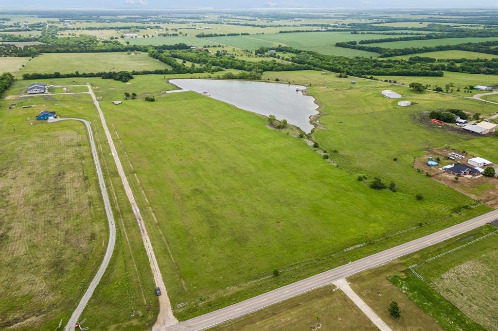 Welcome to the perfect blend of rural serenity and modern potential on this stunning 22.6-acre tract. Offering a beautiful country setting with expansive views and a scenic pond, in Leonard ISD. Located within the Leonard ETJ, this property offers the unique advantage of no city taxes and increased flexibility for land use. This land is an excellent choice for a private ranch, a small cattle operation, or investment. For developers, the ETJ status and local zoning history supports residential subdivision potential. The location is incredibly convenient, situated just minutes from Hwy 69 and Downtown Leonard’s shopping, dining and schools. Just outside the DFW metroplex and a short drive to the new Bois d’Arc Lake. Utilities accessible and a gated entrance from paved FM 272. Currently holds an AG exemption for tax savings. Whether you are building your dream estate or investing in Fannin County’s growth, this versatile acreage is ready for your vision.