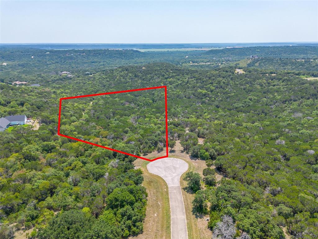 Gorgeous lot in a private, gated golf community outside city limits! THE RETREAT boasts mature trees, a meticulously maintained golf course laid out over rolling hills and big Texas skies. It is the perfect pairing of countryside luxury living just an hour outside Ft. Worth you can find comfort in your community and still be minutes from Chisolm Trail Pkwy and within driving distance to The Stockyards and city life. The Retreat offers a championship golf course designed by PGA Tour Pro Harrison Frazier and was voted Best Value Club by Avid Golfer Magazine, with membership dues landing at only $159 a month! Other amenities include a beautiful rustic clubhouse with a bar and restaurant, 2 community pools, fitness facility, playground, miles of hiking and biking trails, pro shop, fishing ponds, tennis, pickle ball and basketball courts and 24 hour guarded security. Minimum build size is 2,000 sq ft. Come build your dream home and make this community YOUR retreat!