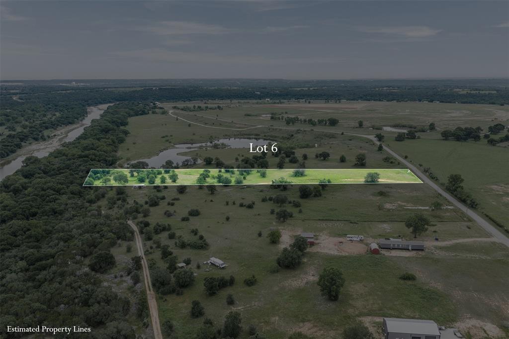 Escape the city on this beautiful parcel nestled in the rolling green pastures. This lush, open lot features mature hardwood trees providing natural shade and character, with a gentle dirt drive already in place leading into the property. Surrounded by native grasses and established tree lines, the lot offers excellent privacy while maintaining an open, buildable interior clearing — ideal for your dream home, barndominium, or weekend getaway.
Enjoy stunning views of a scenic pond just to the east, lush wooded acreage to the north, and wide-open pastureland in every direction. Paved road frontage provides easy access, and neighboring properties reflect the quiet, rural character of the area.
Whether you're looking to build, or simply own a piece of Texas land, Lot 6 checks every box. Wide open skies, and the kind of peace and quiet that's getting harder to find this close to Fort Worth.