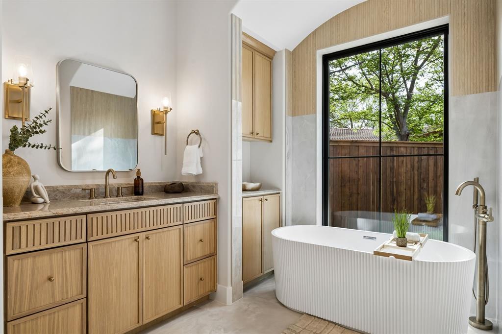 A fresh take on modern luxury, this newly built 4-bedroom, 4 full and 1 half-bath home by Madison Custom Homes offers 3,013 square feet of thoughtfully curated living space where clean design meets everyday functionality. Each bedroom features its own en suite bathroom, creating a private and comfortable layout ideal for both residents and guests.
The main living area flows effortlessly into the kitchen and dining space, making it perfect for entertaining or day-to-day living. A butler’s pantry, powder bath, and dedicated laundry room add both convenience and intention to the layout. The living room is anchored by a striking floor-to-ceiling stone fireplace and filled with natural light, creating a warm yet elevated feel.
Designed with both style and performance in mind, the kitchen features a large island, commercial-grade ZLINE appliances, and a sleek, modern aesthetic. True white oak hardwood floors run throughout the home, complemented by custom exterior doors from Love That Door and Andersen 100 Series windows made from Fibrex composite for superior durability and energy efficiency.
The primary suite offers a private retreat with vaulted ceilings, abundant natural light, and a dedicated sitting area. The spa-like en suite bath includes heated floors, a soaking tub, expansive walk-in shower, and a spacious custom walk-in closet.
Outside, enjoy beautifully landscaped grounds, a large grassy yard, and a covered patio with a built-in grill area, perfect for entertaining year-round.
Ideally located in North Dallas, this home offers convenient access to major thoroughfares including the Dallas North Tollway and President George Bush Turnpike, making commuting a breeze. Just minutes from top shopping, dining, and everyday essentials, the location combines neighborhood charm with exceptional accessibility.