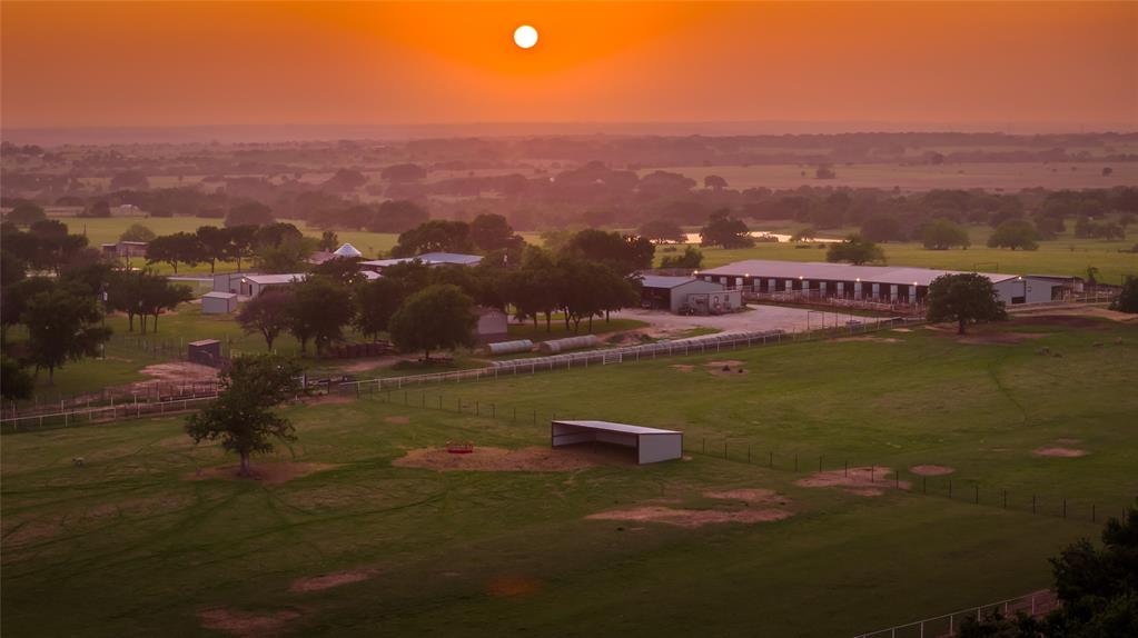 Now offered for Sale in Erath County, the Fraze Ranch once know as Home of Freckles Playboy brings functionality with all the amenity's of a working ranch. Designed on 92 acres with some of the best views and trees you'll find is a rare! Currently a show lamb facility but with little effort it will easily convert over to Equine. Equipped with multiple barns, large turnout pens, easy rotation, and set up for a one man show.  The home offers todays modern charm and yesterdays uniqueness thru used material from old structures of the past. A full wrap around porch and stunning rock accents for flowerbeds, columns, and landscaping bring in the finishing touch. Thoughtfully designed pool and play area to host family gatherings and to entertain and flow with the type of property it sits on. Darling full bunkhouse, additional MH, and large packaging office. Features of the barns include a 6 stall buck barn, massive 16 stall show barn with split gates, holding barn, and a separate vet lab area. Both barn are set up with heating units and fans throughout, automatic waters, and spray foam insulation. You will appreciate the details of this ranch which shows how well it is maintained and well kept, the improved pasture, and layout. Several directions to go with this property rather it be equine, sheep, or show cattle. The opportunity is endless!