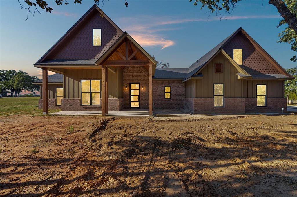 This one hits all the right notes: new construction, 2 acres with trees, and that perfect mix of rustic charm and modern design. Sitting at 2,709 square feet, this 4-bedroom, 3.5-bath home was built for comfort, space, and style.
Step inside and you’ll feel it right away. Warm tones, dark-stained cabinets, luxury vinyl plank flooring, and a floor plan that actually makes sense. The kitchen is a standout with a hidden walk-in pantry and plenty of room to cook, gather, and entertain. The living room centers around a propane fireplace insert, giving the space that cozy Texas feel year-round.
The primary suite is a true retreat with a freestanding soaking tub, walk-in shower, and all the little details that make it feel special. Upstairs, you’ll find a large bonus room complete with its own full bathroom, perfect for guests, a game room, or a private office setup.
Outside, you’ve got 2 full acres to enjoy with mature trees, open sky, and space to make it your own. It’s that hard-to-find blend of peace, privacy, and craftsmanship, all wrapped up in a beautiful rustic exterior.
This home delivers everything you want in modern country living: thoughtful design, quality finishes, and that unmistakable VYBE.
