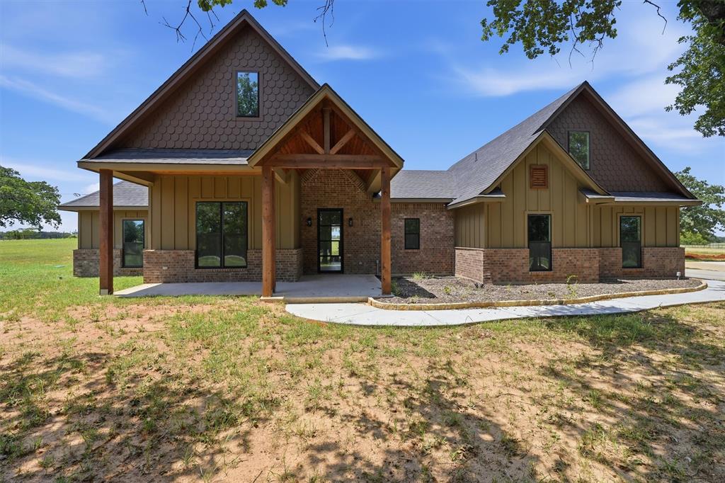 This one hits all the right notes: new construction, 2 acres with trees, and that perfect mix of rustic charm and modern design. Sitting at 2,709 square feet, this 4-bedroom, 3.5-bath home was built for comfort, space, and style.
Step inside and you’ll feel it right away. Warm tones, dark-stained cabinets, luxury vinyl plank flooring, and a floor plan that actually makes sense. The kitchen is a standout with a hidden walk-in pantry and plenty of room to cook, gather, and entertain. The living room centers around a propane fireplace insert, giving the space that cozy Texas feel year-round.
The primary suite is a true retreat with a freestanding soaking tub, walk-in shower, and all the little details that make it feel special. Upstairs, you’ll find a large bonus room complete with its own full bathroom, perfect for guests, a game room, or a private office setup.
Outside, you’ve got 2 full acres to enjoy with mature trees, open sky, and space to make it your own. It’s that hard-to-find blend of peace, privacy, and craftsmanship, all wrapped up in a beautiful rustic exterior.
This home delivers everything you want in modern country living: thoughtful design, quality finishes, and that unmistakable VYBE.