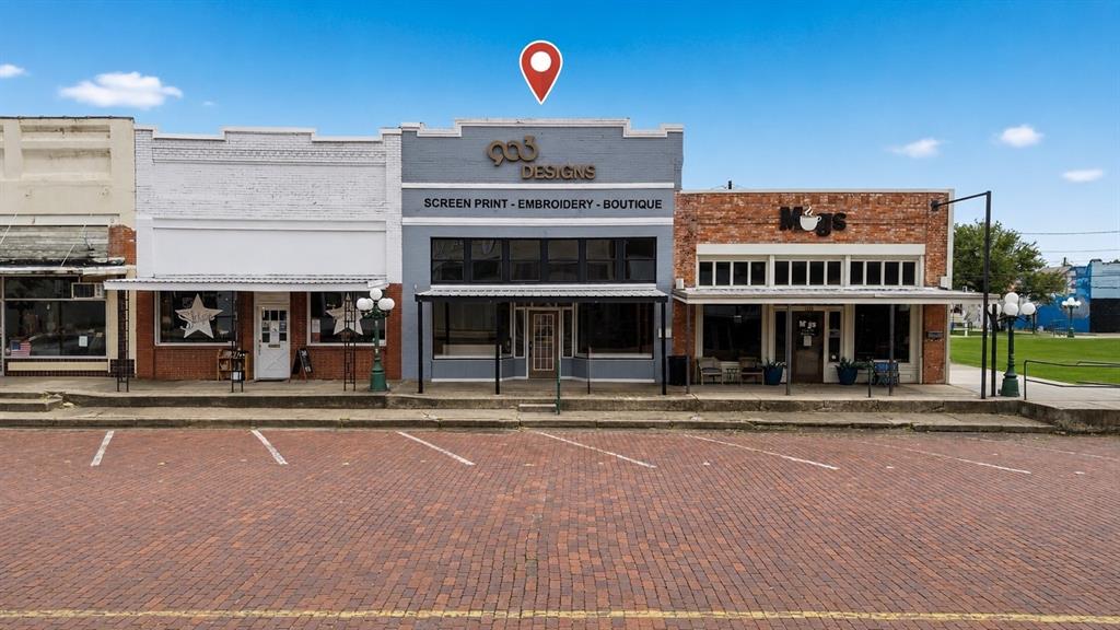 Position your business in the heart of thriving downtown Commerce, Texas! This unique commercial building, formerly home to the well-known 903 Designs screen printing, embroidery, and boutique business, offers outstanding visibility and endless possibilities for retail, office, service, studio, event, or mixed-use ventures. Inside, you’ll find an impressive open-concept storefront featuring soaring ceilings, original exposed brick, character-rich historic walls, large display windows overlooking the brick streets of downtown, and ample space to bring your vision to life. The property also includes additional warehouse or storage space, loft areas, workrooms, and restroom facilities, providing flexibility for a variety of business operations. Located just steps from Mugs Coffee Shop and surrounded by local businesses, restaurants, and daily foot traffic, this property benefits from its prime location in a growing university town anchored by East Texas A&M University. Whether you’re an investor, entrepreneur, or expanding business owner, this is a rare opportunity to own a piece of historic downtown Commerce.