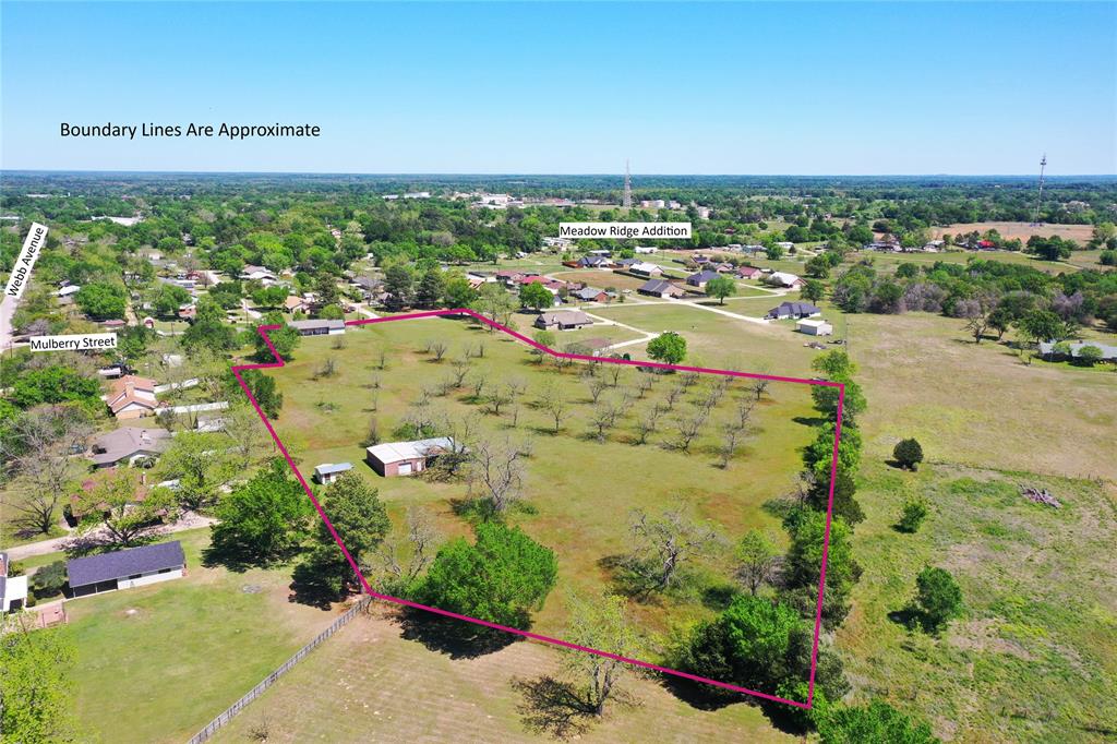 This stunning 7.62 acre estate is a rare find offering incredible versatility within the city limits!  If 7.62 acres is too large, SELLERS WILL DIVIDE! Perfectly suited for a single homesite or a high-potential residential subdivision with the ultimate best of both worlds lifestyle, while staying perfectly connected to town activities, school, and businesses.  Featuring a productive Pecan orchard, you can envision buidling your dream home amongst the shade trees with plenty of room for your animals. The property is already equipped for work and play with a sturdy 30x40 workshop & a lean-to for housing your tractor, boat, or outdoor gear.  The potential here is limited only by your imagination.  No Deed Restrictions!  Whether you’re looking to build a custom home or seeking a prime development opportunity for a new subdivision, this property will meet your expectations!  While there is an existing mobile home on the property, it is currently uninhabitable and holds no value.  New survey available.  (Note: Seller to reserve all mineral rights.)