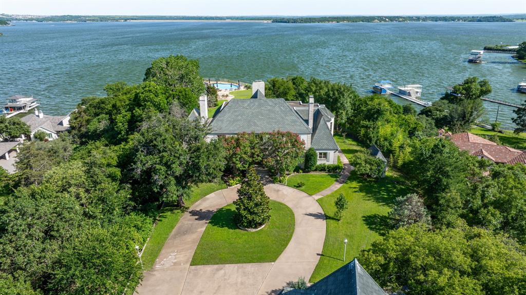 One of Eagle Mountain Lake's finest private Estates on the lake's most desired road, deepest part of the lake and a short distance to the nationally recognized Fort Worth Boat Club. 'CRYSTAL BLUE PERSUASION' from the pool setting gets you 'FEELIN ALRIGHT' from the 'BLUE SKY' views to the 'NORTHERN SKY' views and is as sweet as 'TUPELO HONEY'. 5.4 acres, 200' of waterfront, 12 beds and 11.5 baths, over 9,300' between the house and guest house and pool house gives you that 'PEACEFUL EASY FEELING' 'FOR WHAT IT'S WORTH'! Plenty of room for parties and celebrations. EML has been listed as the best sailing lake in Texas so 'SAIL ON' or 'SAILIN' THE WIND' as you 'TAKE IT EASY'. You have a commanding view of the many sailboat Regattas, races. 'CAN'T YOU SEE' to 'LISTEN TO THE MUSIC' as this isn't just any 'UP ON CRIPPLE CREEK' lake property! Call it a new 'BEGINNINGS', 'THANK YOU'.