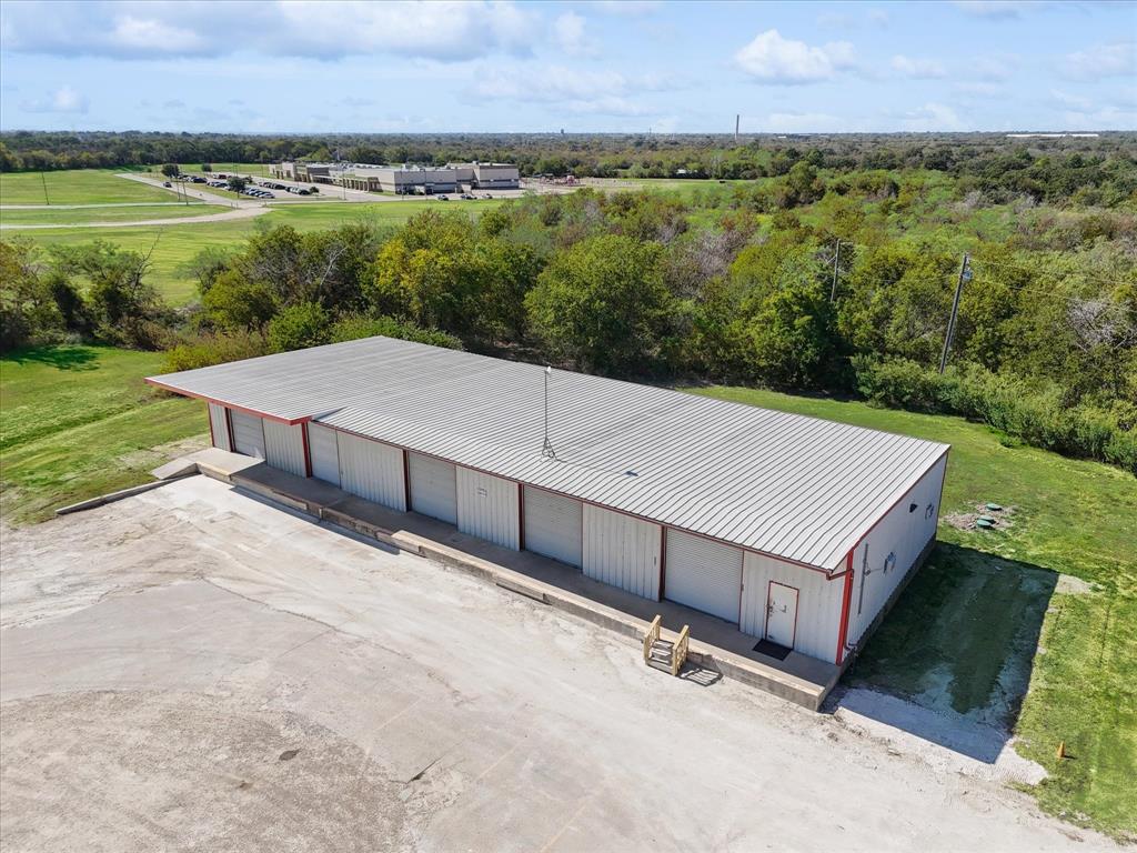 Light Industrial Warehouse Space with 5-Bay Doors and 4200 SF space with an office and a restroom, just East of Cleburne off Henderson.  Enjoy approximately one full acre of land and an updated aerobic septic system.  The structure has 5 overhead garage doors and several strong ventilation fans.  This space was recently vacated by a major consumer snack distribution company and has been cleared out and is ready for your business.  Buyer and Buyer's agents are responsible for clearing any planned use with the City of Cleburne, and for any permitting or special use.  This is an extremely well built structure with a very thick slab and solid metal and steel construction.  Existing elevated bays could easily be converted to ramps for drive-in access.