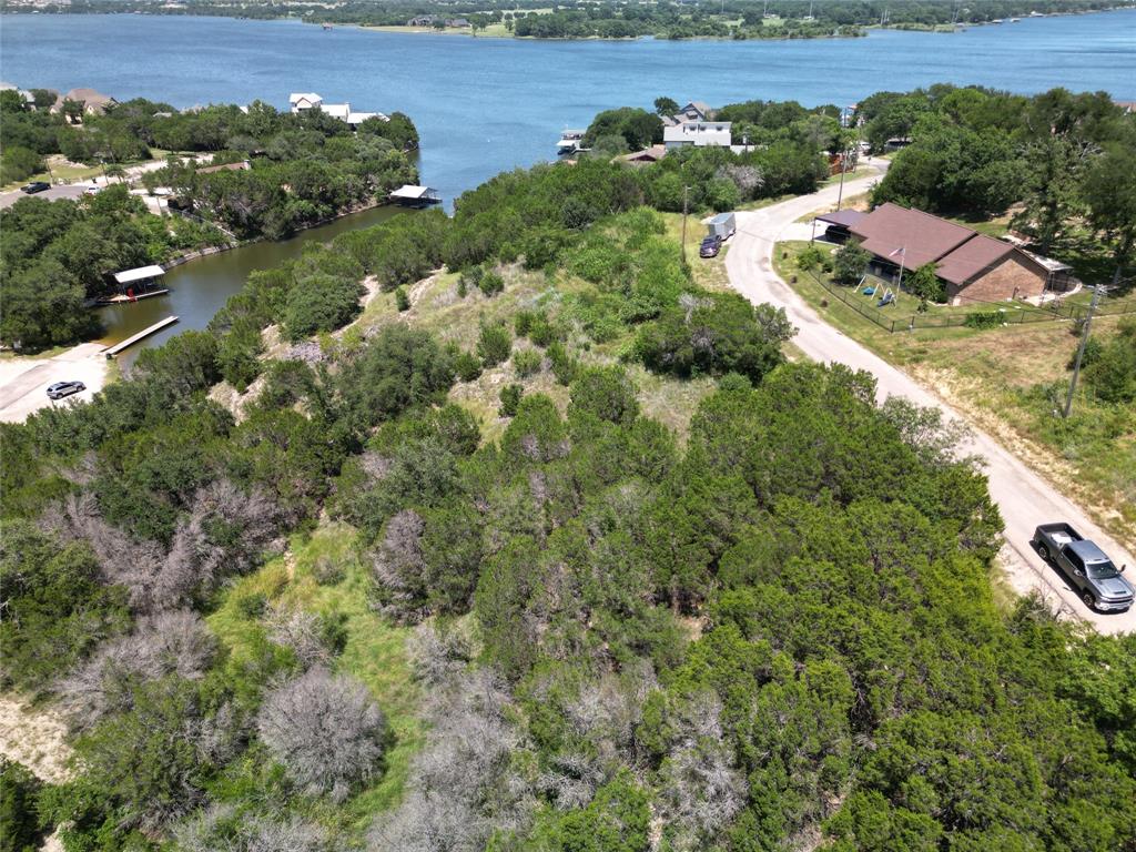 Vacant Lot, great opportunity to with Your Own Blank Canvas and build your dream home overlooking the amazing views of Lake Granbury. Nestled in a peaceful neighborhood near Lake Granbury, this lot offers a blend of country charm and city convenience. This lot is ready for your future home, weekend retreat, or investment property. Just minutes from the historic Lake Granbury Square, you’ll enjoy local dining, shopping, lake access, and more.  ANY Photo's displaying a home are an Artistic Concept and there is no Home on the property. Seller Does Not have blueprints or designs since this is an Artistic Concept of the possibilities that could be possible with this property.