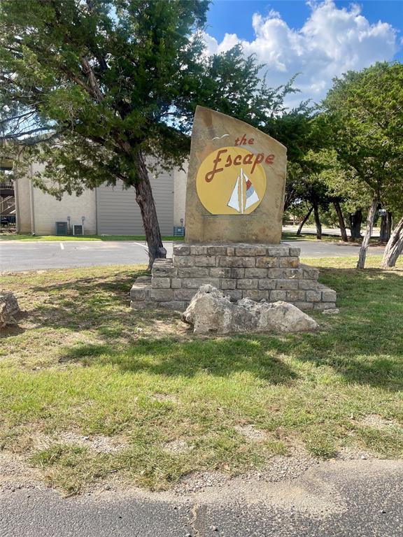 Here is your chance for a GREAT DEAL on a PK Lake Place ~ come see it for yourself! This condo has undergone some nice updates - wood-look tile flooring throughout (no carpet), new kitchen cabinets (missing hardware), updated countertops and farm sink, stainless steel range and dishwasher, fully remodeled bathrooms, updated window coverings, and some updated lighting.  Lighting and ceiling fans are not present in some rooms - it appears the improvement project was left as incomplete.  This one is a primed canvas for you to turn into your dream condo! With an open living - kitchen area, sliding doors leading to a balcony deck, two bedrooms - one with an en-suite bath, and a great location on Possum Kingdom Lake, this condo would be an ideal place for your summer weekends or as a full-time residence.  The Escape Condo complex has space for parking your boat trailer, the pool is within walking distance and the marina is just a short ATV ride down the road.  The Sportsmans World Community features additional amenities for your enjoyment: access to the award winning Bluff Creek Marina and ship store for easy boat access to the lake just minutes from Hell's Gate; an airstrip for those who want to fly-in; use of the community pool, tennis or pickle-ball courts; community trash facility and car wash conveniently located near the condo, community volunteer fire department, plenty of neighborhood activities and a GREAT VIEW of the ANNUAL HELL'S GATE FIREWORKS.