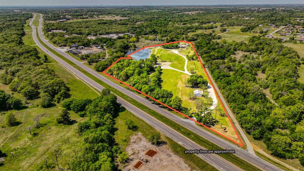 Premier Event Venue and Development Opportunity on US Highway 180.
Spanning 15.92 acres along the highly trafficked US Highway 180 (Mineral Wells Hwy), this exceptional property boasts over 1,100 feet of valuable Highway 180 frontage and is located just 4 miles from historic downtown Weatherford, Texas.

This versatile property has long served Parker County as a popular event center, conference center and wedding venue. It includes three primary buildings, a historic log cabin, and beautifully wooded acreage with several trails and garden areas.
 Main Building
The two-story main building features:
3264 sqf total
two restrooms
 Dressing rooms
 Bar and kitchen area
Upstairs event space: 600 sf, seating for 50 guests
 Main floor: covers over 2600 sf and seating for 120 guests
 Pavilion
The second building is a spacious pavilion, ideal for smaller gatherings, with:
2007 sf of covered space, two restrooms and a kitchen and will seat 125 indoors and 250 outdoors.

Located at the entrance of the property is an office featuring:
1200 sf of space and one full bath
 Additional Features
A charming historic settler’s log cabin located beside the main venue, offering potential as a short-term rental with minimal renovation
 Numerous mature trees, gardens and scenic trails across the front of the property along with a small lake, private water well and 3 septic systems.
Behind the main event building is a lighted outdoor entertainment area that includes a stage, dance floor and covered seating.
 Investment Potential
This property offers exceptional potential for future development, such as an RV park, Industrial Park or can continue as a turnkey event center.
Don't miss this rare opportunity to own a prominent piece of Parker County real estate with endless possibilities.
Buyer and Buyers agent should confirm all information is accurate.