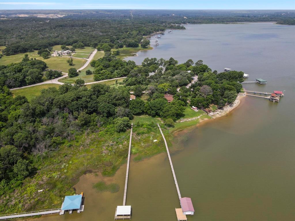 Stunning Lakefront Property on Lake Worth with a pool and a dock! This exceptional lakefront lot spans over half an acre, offering an unparalleled opportunity to create your own private retreat. As you enter the property, you’re welcomed by a beautifully landscaped, fully fenced property with ample space for recreation, relaxation and ready for building your dream home.  Enjoy direct access to the lake with your private boat dock, a boat lift, and open water views that stretch for miles. Whether you're into boating, fishing, or simply soaking in the tranquility, this is an ideal setting. A private swimming pool adds to the resort-style feel, perfect for cooling off after a day on the water.  With mature trees, the property provides a secluded ambiance, blending nature with luxury. Rarely does a lot like this become available—don’t miss the opportunity to own a slice of Lake Worth paradise.