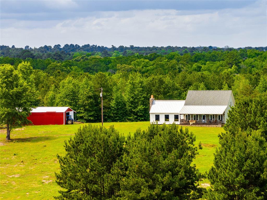 Welcome to Kreager Ranch, a heavily wooded 330.832-ac property nestled in Houston County. This recreational haven is perfect for those who love nature, hunting, or simply wish to find a peaceful retreat away from city life. The property has dramatic elevation change from about 310' to 420' ASL, which adds to its scenic variety and potential for building ponds or water features, using the natural creeks and drainage areas found throughout. Most of the land is covered with 25 to 30-year-old plantation pine trees that have been selectively thinned to promote healthy growth and maintain the natural beauty. The heart of the ranch is its charming four-bedroom, two-and-a-half bathroom home with approximately 2,140 SF of GLA.  improvements include a functional barn-shop structure, a vineyard within an eight-acre high-fenced area, and two deep wells—one with a solar system for the vineyard and another for residential water needs. Schedule your showing today!