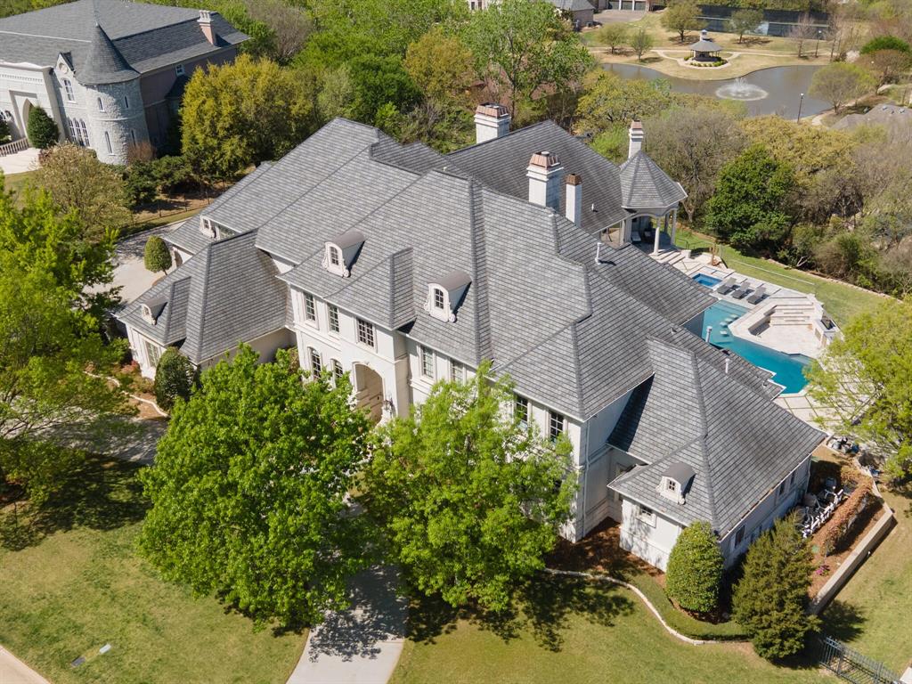 Perched atop a scenic hill in Arlington, Texas, 2600 Royal Glen Drive is a well-appointed estate home with views worthy of a magazine cover. Loch Highland Estates offers seclusion and privacy with vistas overlooking the Texas sky and a soaring landscape. Every feature is crafted to the highest standard, with custom hand painted sinks, hand scraped hardwood floors, custom marble, and intricate architectural details that lend a refined air to the home. Outside, the sunken resort-style pool overlooks the western vista. Patio features multiple living and dining areas and is highlighted by tiles imported from Turkey. Outdoor kitchen boasts a pizza oven and a hidden retractable TV. Tennis court is ideal for outdoor sport enthusiasts with a half bath accessible from the exterior for use when outdoors. Inside, gourmet kitchen, primary suite, and private study are the pinnacle of luxury living. View the linked website for extended property description, amenities, and neighborhood attractions.