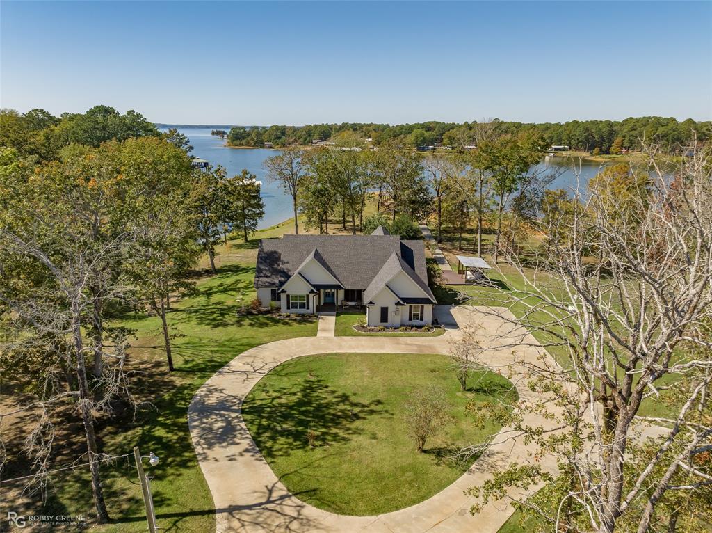 This South Toledo Bend lakefront home is nothing short of extraordinary. Nestled amidst the serene beauty of nature, this remarkable home offers a blend of luxurious living and tranquil surroundings that's truly unparalleled.
The four-bedroom, three-bathroom layout provides ample space for both family and guests.
The 2-stall boathouse is a boater's dream, allowing you to easily access the crystal-clear waters of Toledo Bend Lake for fishing, water sports, or simply enjoying a leisurely cruise.
Surrounded by lush woods and the calming waters of the lake, this property provides a sense of seclusion and tranquility that is truly priceless. 
The 2018 construction boasts a built-in refrigerator and GE Monogram 48-inch dual fuel range. Custom tile and woodwork showcase the home's unique character, while sliding mahogany doors in the dining area add a touch of versatility, making it the perfect space for a home office.
Truly, it's a remarkable home in a truly exceptional setting.