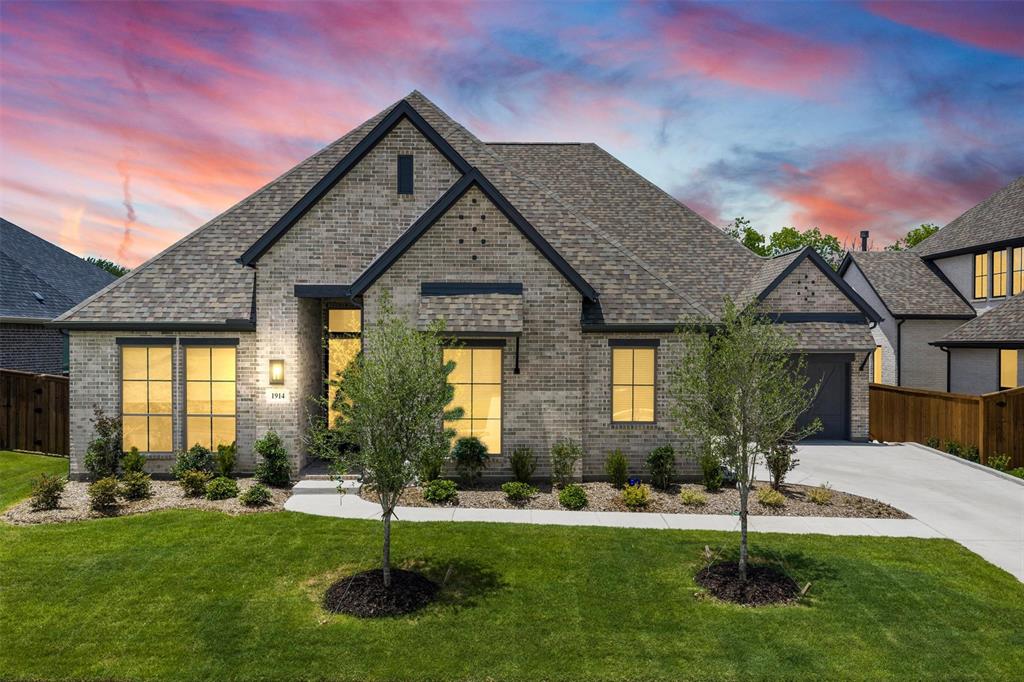 Exceptional single-story home in Rockwall ISD featuring 4 bedrooms, 3.5 baths, a private office, media room, and a rare multigenerational floor plan. One of the home's most unique features is the private guest suite with its own separate entrance, full bath, walk-in closet, and dedicated garage access—ideal for a mother-in-law suite, extended family, live-in caregiver, or long-term guests seeking privacy and independence. A welcoming front porch and grand entry with soaring 12-foot ceilings lead to a private office with French doors. The open-concept family room showcases hardwood floors, a wood mantel fireplace, and a wall of windows overlooking the backyard. Expansive sliding glass doors fully open to create seamless indoor-outdoor living, perfect for entertaining. The chef's kitchen features a large island, double wall ovens, 5-burner gas cooktop, walk-in pantry, and abundant prep space, flowing effortlessly into the dining area and bright morning room surrounded by windows. The secluded primary suite offers 13-foot ceilings and peaceful views of the wooded backyard. The spa-inspired bath includes dual vanities, a freestanding soaking tub, glass-enclosed shower, linen closet, and two walk-in closets. Two secondary bedrooms share a full bath, while the private guest suite enjoys its own bath. A media room with French doors, mudroom, utility room, powder bath, and three-car split garage complete this thoughtfully designed home. Step outside to the extended covered patio and enjoy one of the property's most desirable features—a private backyard backing to mature trees with no neighbors directly behind, creating a peaceful setting rarely found in newer construction. Residents enjoy resort-style amenities including a pool with lap lanes, pickleball and tennis courts, parks, playgrounds, stocked fishing ponds, walking trails, and Rockwall ISD schools. Combining luxury, privacy, and exceptional flexibility, this home offers a lifestyle that's hard to find.