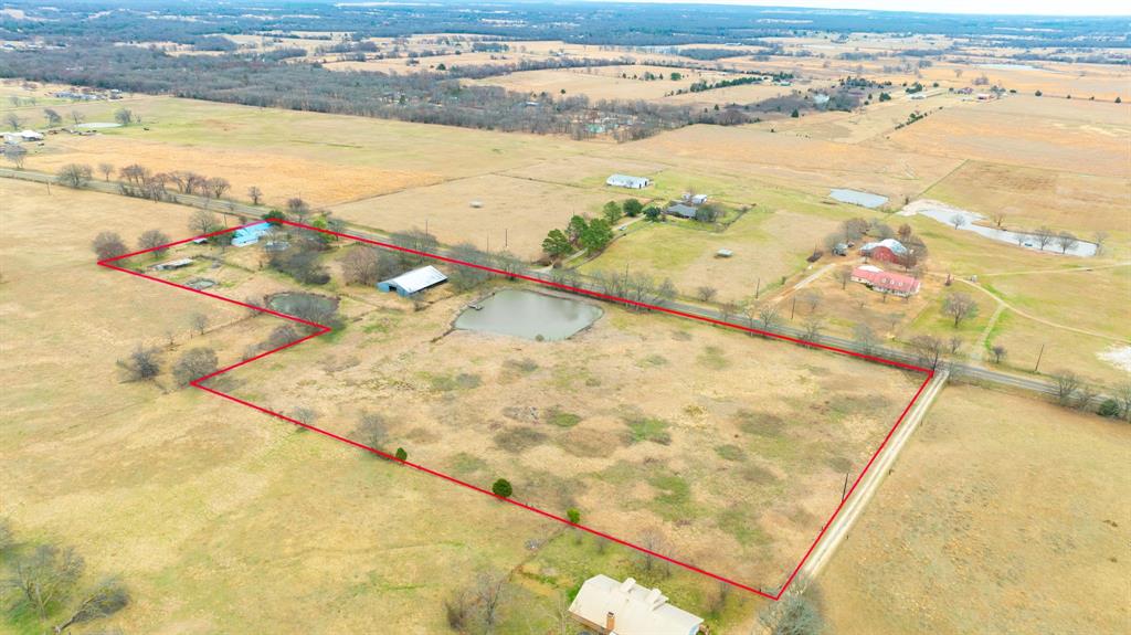 Need room to roam? Here it is. Nearly 10 acres of East Texas countryside with water, workspace, and a farmhouse full of character. This 9.8-acre tract gives you the freedom most people only talk about. Two tanks perfect for fishing and relaxing evenings by the water. A Huge barn with stalls ready for horses, cattle, or livestock. Two storage sheds, including one insulated for equipment, feed, or projects. The farmhouse welcomes you with a spacious living area designed for gathering. A durable metal roof adds peace of mind. You’ll also find a bonus room, plus a sun or mud room perfect for boots and mornings with coffee. The enclosed garage provides even more storage. Located approximately 60 miles from downtown Dallas and downtown Tyler, and less than 20 miles from Canton and its Historic trade show, you get the best of both worlds. Peaceful country living with easy access to town. Bring the horses. Run cattle. Start the garden. Cast a line in your own backyard. Opportunities like this don’t come along often. Schedule your showing today.
Please verify measurements.