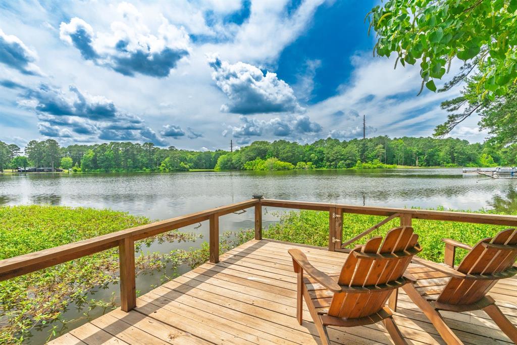 Tucked away on 1.7 beautiful waterfront acres, this private lakefront retreat offers the perfect blend of peaceful seclusion & everyday convenience. Surrounded by towering mature trees & breathtaking water views, the property feels like a world of its own while remaining just minutes from town. Designed to embrace the beauty of its surroundings, the 3-bedroom, 2-bathroom home features a spacious sunroom where walls of windows frame picturesque views of the lake and lush landscape, creating the perfect spot to enjoy your morning coffee, watch local wildlife, or simply unwind in the tranquility of nature. Step outside to the expansive back deck, an ideal space for entertaining family & friends or relaxing beneath the shade of the mature trees while taking in the peaceful waterfront setting. A private walkway leads directly to the pier, making it easy to spend your days fishing, boating, or simply soaking in the beauty of lake life. As evening arrives, the property truly shines with incredible sunset views stretching across the water, providing a stunning backdrop for gatherings or quiet moments of reflection. The combination of mature trees, waterfront access, and panoramic views creates a rare sense of privacy & retreat that is increasingly difficult to find. Whether you're looking for a full-time residence, weekend escape, or a place to create lasting memories with family & friends, this special property offers the serenity of lakeside living without sacrificing the convenience of nearby shopping, dining, & amenities. A Note From the Seller: What we love most is the feeling of peace this property provides. The sunsets over the lake never get old, & the views from the sunroom, deck, & pier make every season special. The mature trees create a sense of privacy & beauty that makes you feel miles away from everything, yet you're still just a short drive from town. It's the perfect place to relax, reconnect, & enjoy everything that lakefront living has to offer.