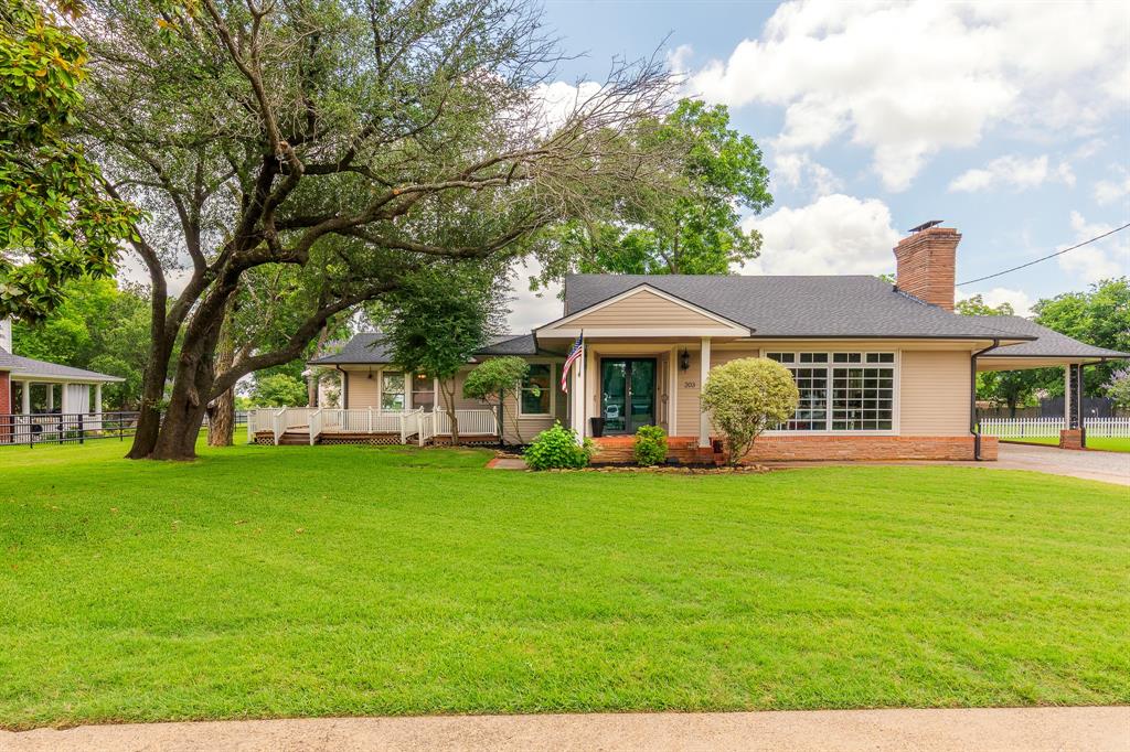 Nestled in Van Alstyne’s coveted Historical District and rich with character, this one-of-a-kind home offers the perfect blend of timeless charm and modern versatility. Just steps from historic downtown, boutique shopping, local dining, and the beloved Railcar Farmers Market, the location is truly unmatched.

Situated on a beautifully landscaped oversized lot with mature trees, this property invites you to enjoy outdoor living with a welcoming covered back porch, expansive backyard, and a wood deck that wraps around the rear of the home—perfect for entertaining or relaxing evenings at home.

Inside, you’ll find vaulted ceilings, warm wood flooring, stainless steel appliances, and spacious living areas designed for both everyday comfort and gathering with guests.

A rare and valuable bonus, the detached two-car garage offers incredible flexibility with a private office on the ground level, while the upstairs features a charming one-bedroom apartment complete with a full bath and kitchenette—ideal for guests, multigenerational living, a private workspace, or potential income-producing opportunities. An attached two-car carport adds even more convenience.

This historic Van Alstyne treasure is full of character, possibilities, and an unbeatable location.