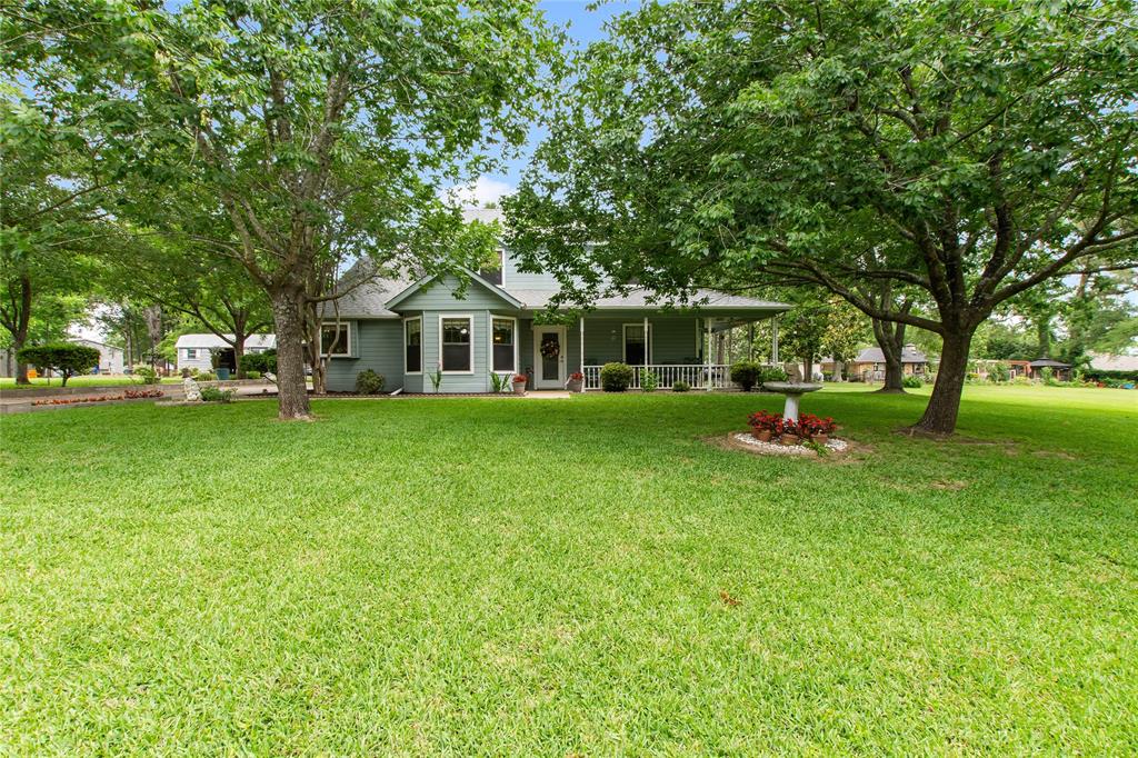 Charming country cottage nestled in Key Ranch on a peaceful, quiet street, offering the perfect blend of space, comfort, and country charm. Situated on four lots surrounded by mature trees and lush green grass, this inviting property features 3 bedrooms and 2.5 bathrooms with a desirable floor plan including a private primary suite downstairs and two guest bedrooms with a full bath upstairs.

Inside, you’ll find new laminate flooring throughout the living room, dining area, laundry room, and kitchen, creating a fresh and welcoming feel. The kitchen offers beautiful wood cabinetry, a built-in double oven, cooktop, and dishwasher, along with both a formal dining room and a second casual dining area ideal for everyday living and entertaining.

The spacious wraparound porch and covered breezeway provide the perfect setting for relaxing mornings, outdoor gatherings, or simply enjoying the peaceful shaded yard. The property is well-equipped with a 2-car garage featuring upstairs space that could easily be transformed into a loft, bonus room, or hobby area, along with a 2-car carport, storage room behind the garage, additional storage shed, and a well for sprinklers.

Full of character and curb appeal, the exterior and landscaping showcase timeless country cottage charm, while the interior presents a wonderful opportunity for buyers to add their own personal touches. With generous outdoor space, versatile amenities, and a serene setting, this property is ready to welcome its next owners home.