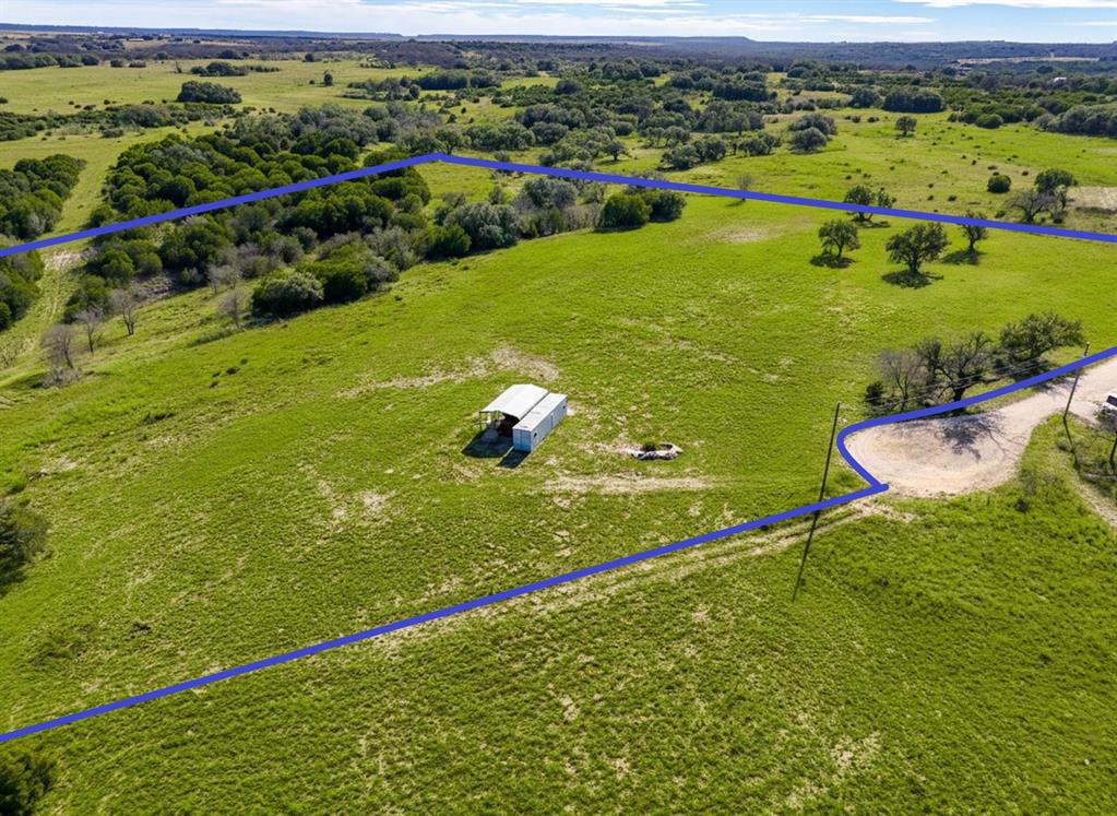 The iconic line The stars at night are big and bright, deep in the heart of Texas fits perfectly here.
Nestled in the gated Honey Creek Ranch community just 5 minutes from charming, historic Hico. This rare hilltop parcel offers two contiguous 10 acre lots (20 acres total) at the end of a quiet culdesac with a breathtaking view.
Cleared and ready, it boasts:

   Unparalleled 360 degree panoramic views from elevated terrain
    Electricity already on-site
    A well-maintained container home with 2 bedrooms and kitchenette perfect as a weekend retreat, guest space, or build base
   Two car carport for convenience

Hico delivers authentic Texas appeal: Explore the Billy the Kid Museum (home to the legendary claim that Brushy Bill was the real Kid), browse boutique shops and antiques in restored downtown buildings, savor gourmet chocolates at Wiseman House, enjoy ice cream parlors, great dining, and riverfront trails.
Ideal for a private escape, family legacy spot, or dream home site in a peaceful, lightly restricted community. Lots may be sold separately.