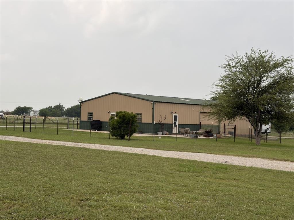 Great barndominium 1bed, 1 bath, with 1600 sq ft shop with 2 rollup doors, concrete floors, custom cabinets, fenced yard, patio, trees, sets back from county road for privacy, corner property, 10.8 acres, water well and septic, RV hookup with 30 and 50 amp and concrete parking, carport, secluded, quiet and peaceful living.