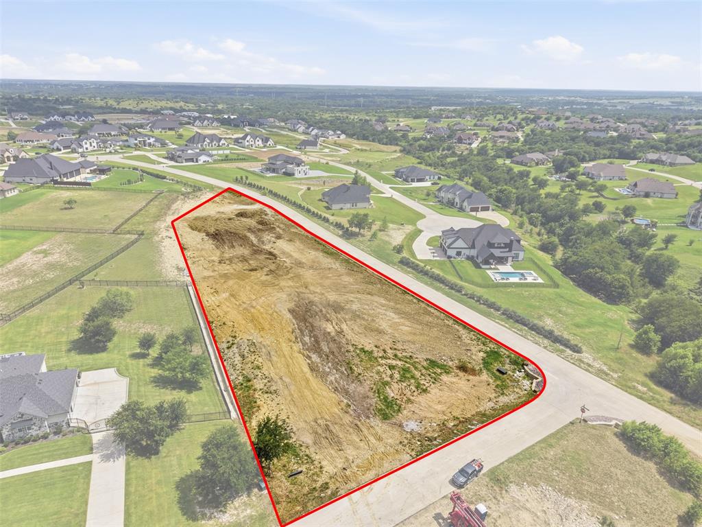 Build your dream home in the highly sought-after Bella Flora community! This beautiful 1.4-acre homesite is perfectly positioned atop a hill, offering breathtaking views and an exceptional setting for your custom estate. Located within the award-winning Aledo ISD, this build-ready lot has already undergone significant site preparation. Improvements include completed grading and fill work, installed drain culverts, a 4-foot retaining wall, and a 3-foot French drain system. With much of the groundwork already complete, this property is ready for you to bring your vision to life. Enjoy the privacy, prestige, and beauty of Bella Flora while being just minutes from shopping, dining, and all that Aledo and Fort Worth have to offer. A rare opportunity to own a premium homesite in one of the area's most desirable luxury communities.