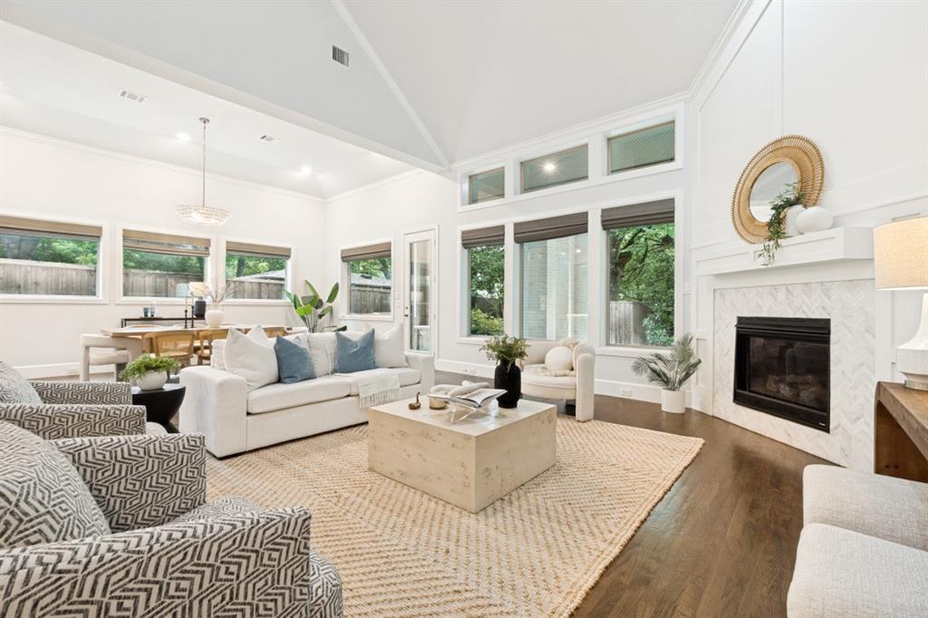 MOTIVATED SELLER!!! MOVE IN READY!! OPEN TO SHORT TERM SELLER FINANCING!! Located on a rare oversized 0.26-acre lot (73’ x 155’) in Lakewood’s Bob O Links Downs, this 2015-built Hill Country–style residence offers 5 bedrooms, 6 baths, and approximately 4,129 sq ft of living space. A glass-paneled front door opens to a spacious entry and a dedicated home office with glass doors. The open-concept main level features rich hardwood floors, high ceilings throughout, and a gas fireplace anchoring the main living area.The kitchen is centered around an oversized marble-topped island with breakfast bar seating, abundant cabinetry, gas range, and GE Monogram appliances, creating a functional layout for everyday living and entertaining. French doors from the living area open to a covered backyard patio with gas fireplace, built-in grill, and outdoor refrigerator. The turfed, level oversized backyard includes a sprinkler system and board-on-board privacy fencing The first floor primary suite features a cathedral ceiling and spa-like primary bath. A guest bedroom and one and a half additional baths on the main level provide versatility for visitors or multi-use needs. BRAND NEW CARPET AND FRESH PAINT THROUGHOUT!! Upstairs includes three additional bedrooms and a large playroom or bonus space. Attached side-entry three-car garage and ample storage. Located minutes from White Rock Lake, Lakewood shopping and dining corridors, and nearby parks. Includes 3D walkthrough and virtual tour media. Oversized lot dimensions, outdoor living features, and a flexible floor plan distinguish this property within the Lakewood area. This is one you won't want to miss!
