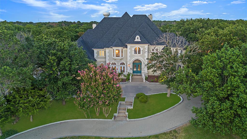 Located right off of the fairway of hole 6, this beautiful Tour 18 estate was recently renovated, and features 4 large bedrooms (each with their own ensuite bath), 2 living rooms, an office with a 2nd story library, a designer kitchen with Viking and Kitchen Aid appliances, an oversized 4 car garage, a covered back patio, a newer pool, and all of the outdoor space you could ever want on over 2 acres! It doesn't even feel like you're in DFW when you enter the front gates--there is something special about the neighborhood that everyone who lives here will attest to. With ample room, amazing amenities, and the beautiful and spacious estate lot, there will not need to be any compromises on this home. Privacy is supreme here, with a guarded gate, and plenty of space between your neighbors, so you can enjoy the serenity that you have been looking for. Come see the breathtaking views, enjoy the excellent schools, and savor the peace and quiet that a 2 acre golf course lot provides!