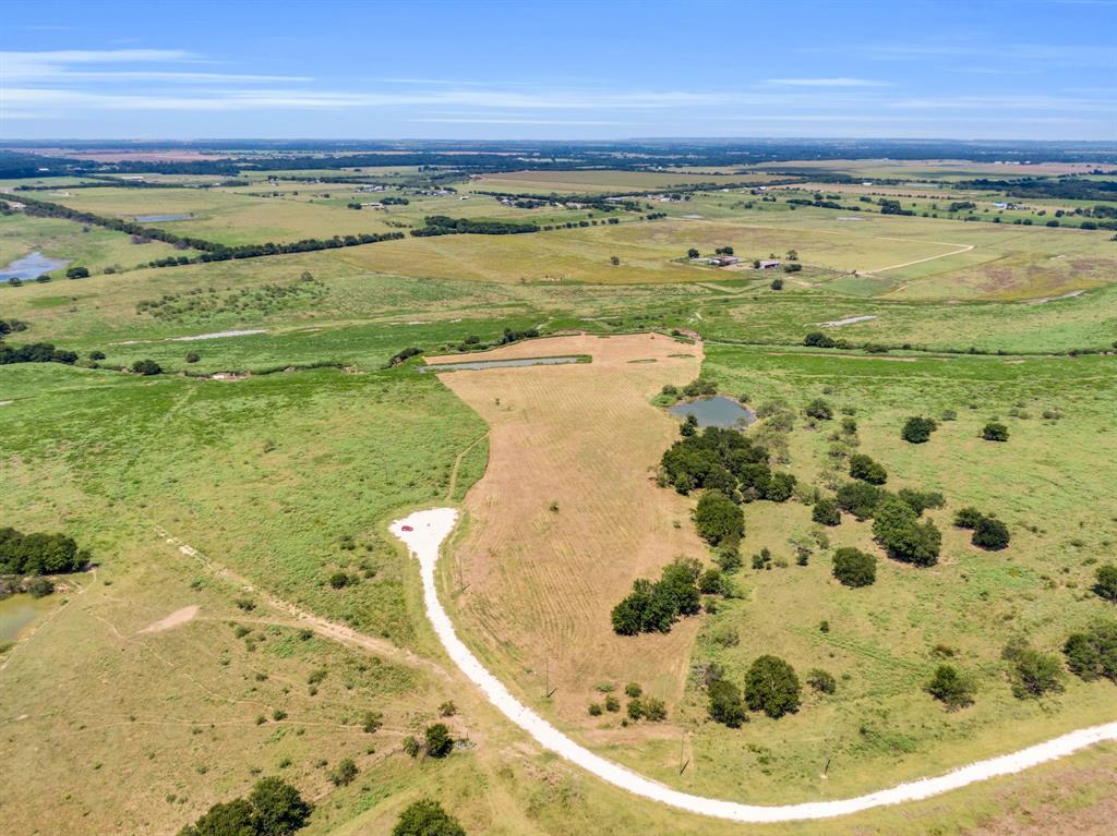 10.2 Acres in the picturesque community of Grand View Ranch! 

Not all acreage is created equal—and this property proves it.

Position your home on the higher elevation and enjoy expansive, UNOBSTRUCTED VIEWS from your back porch—something flat land simply can’t offer. The topography naturally lends itself to a walk-out basement, multi-level design, or a thoughtfully engineered retaining wall, creating a home that feels integrated into the landscape rather than placed on top of it.

Beyond design, the elevation supports improved drainage and usability, helping maintain the integrity of your homesite over time.

Ideally located near the end of a CUL-DE-SAC, the property backs up to a 145-acre ranch on the outskirts of the development, maximizing PRIVACY, PEACEFUL surroundings, and the breathtaking view of OPEN LAND with horses and grazing cattle nearby. A SEASONAL CREEK runs along the rear of the property, adding charm and a natural backdrop.

Whether you’re envisioning a luxury home or a stylish barndominium, you will be in good company—several already dot the landscape of this beautiful ranch community. Deed restrictions help protect your investment by EXCLUDING MOBILE HOMES. Horses are warmly welcomed, and the property is currently AG EXEMPT, keeping your TAXES LOW.

If you’re looking for wide-open spaces, privacy, and peaceful COUNTRY LIVING without being too far from town—this is the land you have been searching for!

** Please reference the survey photo for a clear indication of property lines. The tract was inadvertently mowed in excess of the property boundaries. Specifically, this tract skirts the tip of the pond, it does not include it. Additionally, the property stretches further beyond the stream in the back than what the photos show. 

HORSES, CHICKENS, AND DOMESTIC LIVESTOCK are welcome with the exception of pigs, hogs and peacocks!
Buyers agent to verify all information
