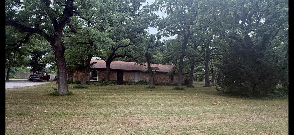 UPLOADED NEW INTERIOR PHOTOS!! LARGE PRICE REDUCTION!! INVESTORS! CHECK THIS ONE OUT! While this house needs repairs and updating, it can certainly be a one-of-a-kind property for you. This home was built with native rock as well as the garage and out-building making it very unique. It has 3 large bedrooms with 2 bathrooms. The large living area has an incredible freestanding native rock fireplace as well. The rock 2 car garage has a large shop at the back of it equipped with a half bath in it. It sets on a beautiful tree covered 0.86 acres lot and has an adjoining 0.85 acres additional lot for you to build an additional house on if so desired. While it does have a well and septic on it, city water and sewer was added later. THIS PROPERTY IS PRICED TO SELL AND THE SELLER IS NEGOTIABLE! CALL TODAY!