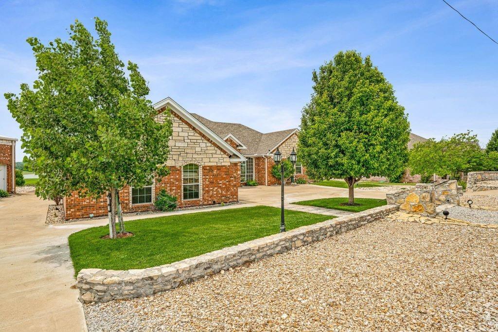 Located in the peaceful countryside of Comanche with breathtaking lake views, this exceptional custom-built estate offers the perfect blend of luxury, functionality, and enduring quality. Situated on approximately 3 pristine acres, this meticulously maintained home was thoughtfully constructed with craftsmanship and structural integrity in mind—offering not just beauty, but the kind of quality construction that stands the test of time.
Inside, you’ll find an expansive and functional floor plan featuring 4 spacious bedrooms, a dedicated office, soaring ceilings, and an open-concept living space designed for both everyday comfort and entertaining. Natural light pours throughout the home, highlighting the timeless finishes including granite countertops, oversized closets, generously sized bathrooms, and a stunning wood-burning fireplace that anchors the main living area.
Step outside onto the enclosed patio where panoramic views of the lake and surrounding countryside create the perfect backdrop for peaceful mornings and unforgettable sunsets.
The impressive shop is truly a standout feature, offering abundant square footage, RV storage, oversized doors, soaring ceilings, and its own bathroom—ideal for hobbies, projects, equipment storage, business use, or recreational needs.
From the thoughtful design to the substantial amenities, this property offers the kind of extras buyers dream about—all wrapped in a home built with quality, care, and lasting craftsmanship. There is so much that this home offers you want to see it!
