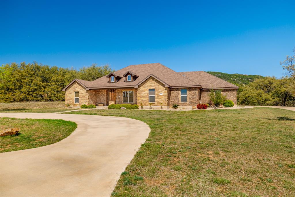 Located in the desirable Sandstone neighborhood, this 5 bedroom, 3 bath home sits on just over an acre and offers stunning views and plenty of space to spread out. Hardwood floors and an open concept layout create a warm and inviting feel, while the living room features vaulted ceilings with beautiful wood beams. The kitchen is built for both everyday living and entertaining with a double island, double ovens, breakfast bar, and a dream pantry with exceptional storage. The primary suite is a true retreat with a spacious bathroom that includes a walk in shower with dual shower heads, soaking tub, double vanity, and a huge walk in closet. The fifth bedroom offers versatility and could easily be used as an office or home gym. Step outside to enjoy the covered patio, firepit, and peaceful surroundings. A standout feature is the storage building complete with electricity and two office spaces, perfect for working from home, hobbies, or additional flex space. This property combines comfort, function, and scenic beauty all in one.