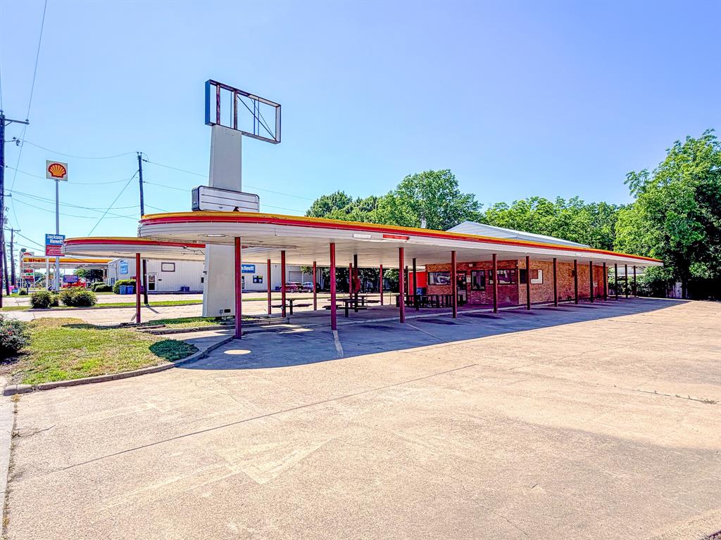 Prime commercial opportunity in the heart of Corsicana! This former Sonic building is ideally situated on busy West 7th Avenue with exceptional visibility and high daily traffic counts, making it the perfect location for your next business venture. Featuring a drive-through and walk-up window, the property is already set up for convenience and customer accessibility. A durable metal roof was replaced in 2016, along with additional improvements to the parking and drive-through areas. Whether you envision a restaurant, coffee shop, retail space, office, or something entirely unique, the possibilities here are endless. Bring your vision to life in this high-exposure location with outstanding potential for growth and success.