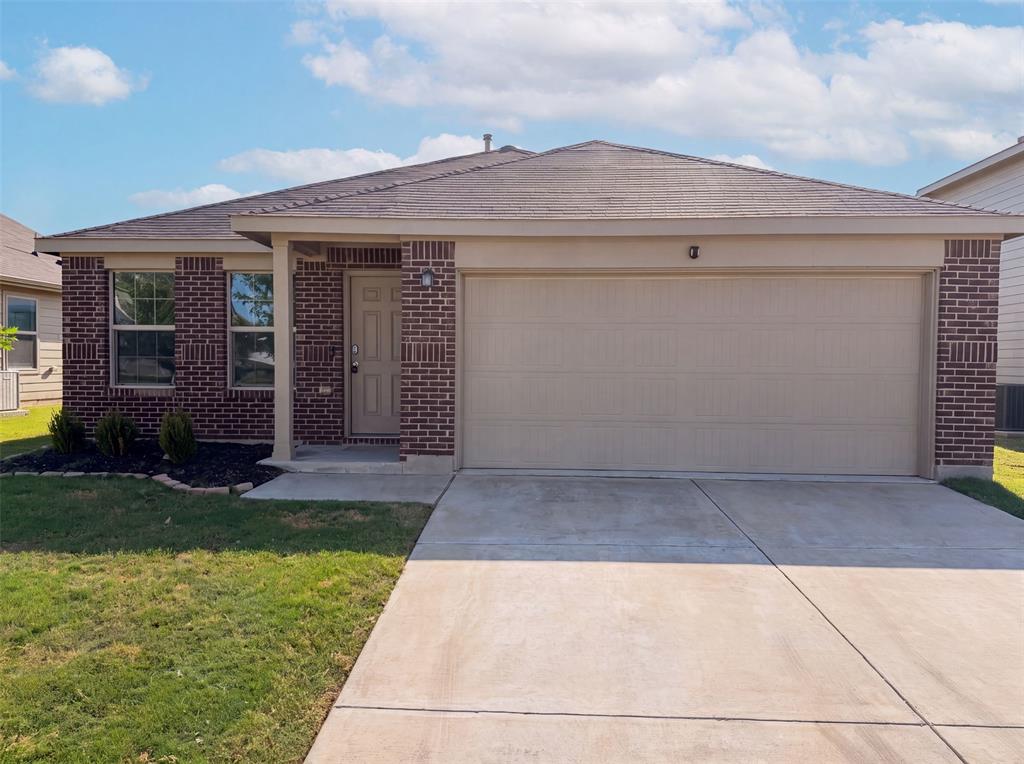 Charming single-story brick home with covered entry & 2-car garage. Wood-look laminate flooring throughout main living areas. Open kitchen features dark cabinetry, speckled countertops, gas range & built-in microwave, overlooking the living & dining space. Spacious bedrooms with neutral paint, one with a soft blue accent wall. Updated bath with tub & shower combo & large vanity mirror. Fenced backyard opens to green space beyond. Move-in ready with a smart layout in a peaceful setting.